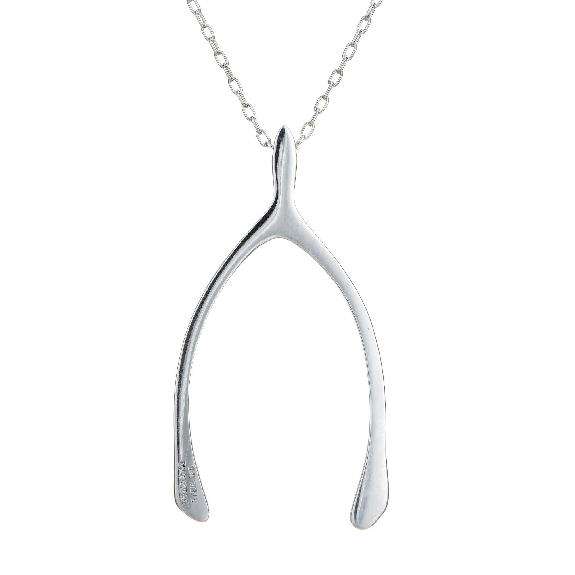 Elegant and finely detailed vintage Tiffany & Co sterling silver heart necklace.  

The wishbone is larger in scale (1.75 x 0.88 inches) and is attached to a 15 inch Tiffany & Co chain. The necklace sits nicely below the nape of the neck.

The