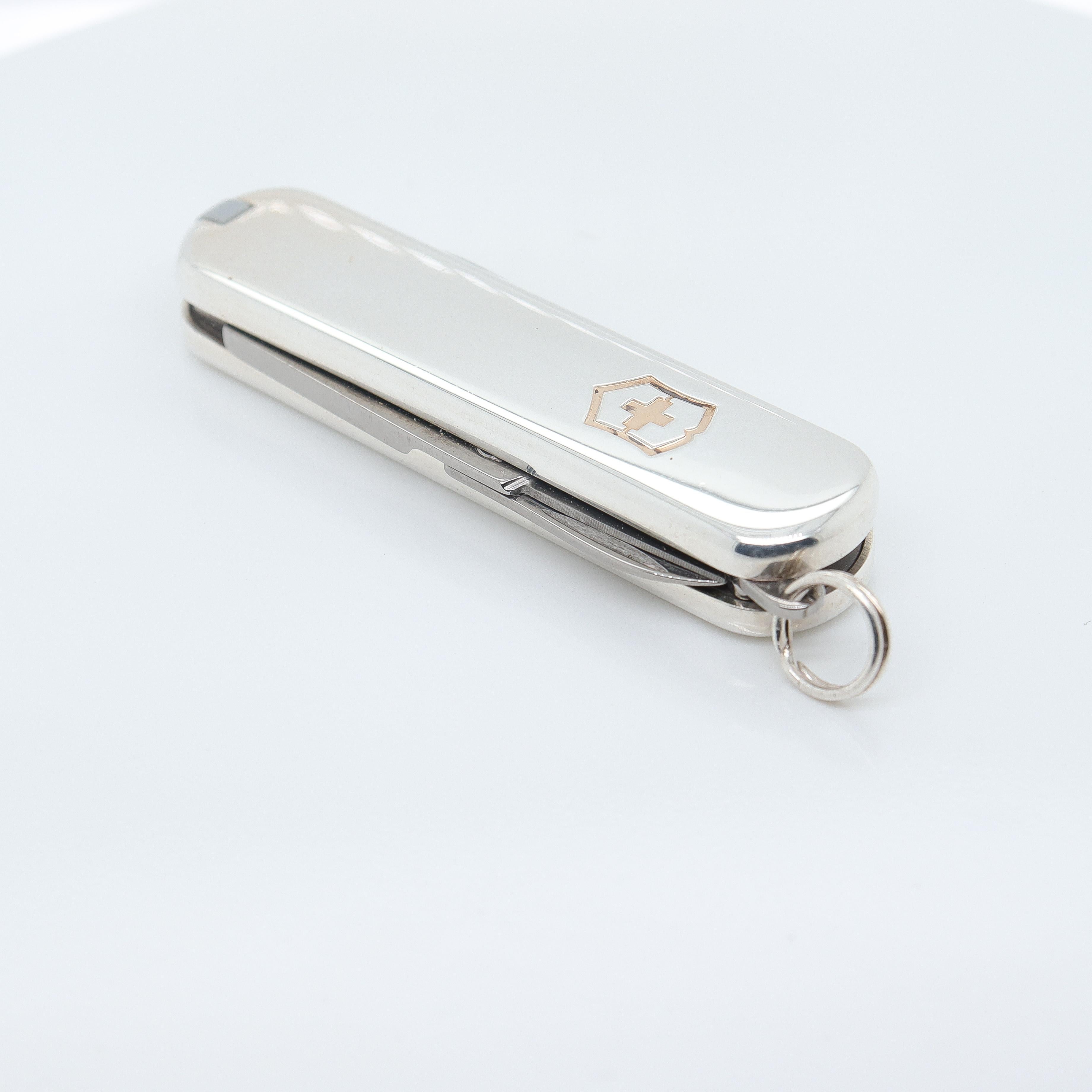 A fine vintage silver Swiss Army pocketknife.

In sterling silver & 18K gold.

By Tiffany & Co. in collaboration with Victorinox.

Contains a knife, scissors, and a nail file. The inlaid Victorinox shield and the bed of the file are finished in 18K