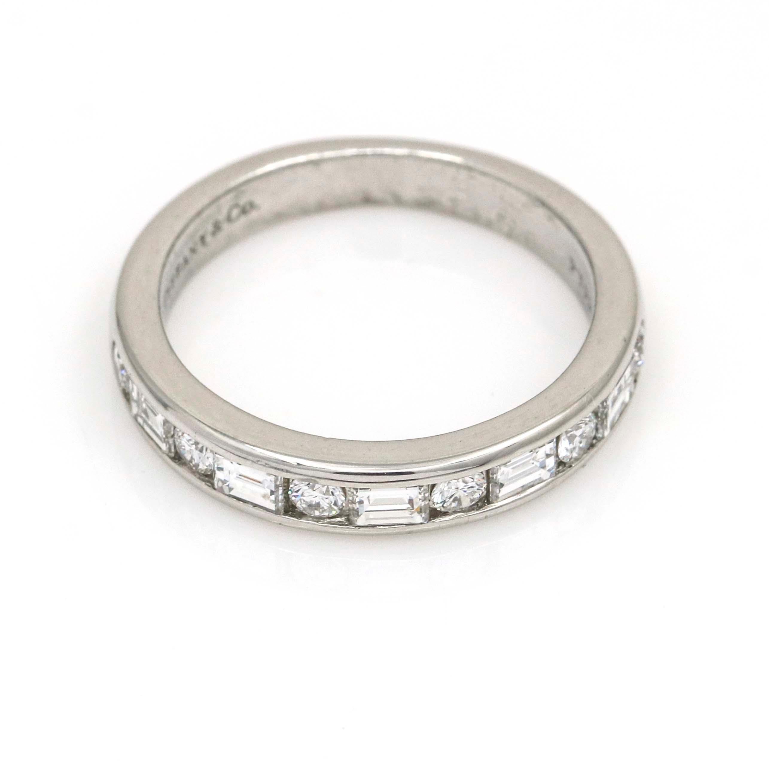 Tiffany and Co. women's half eternity band featuring 11 channel set brilliant round and baguette-cut diamonds crafted in platinum. Adaptable, timeless design perfect for wedding, anniversary band, or stackable ring. Inside shank marked Tiffany & Co.