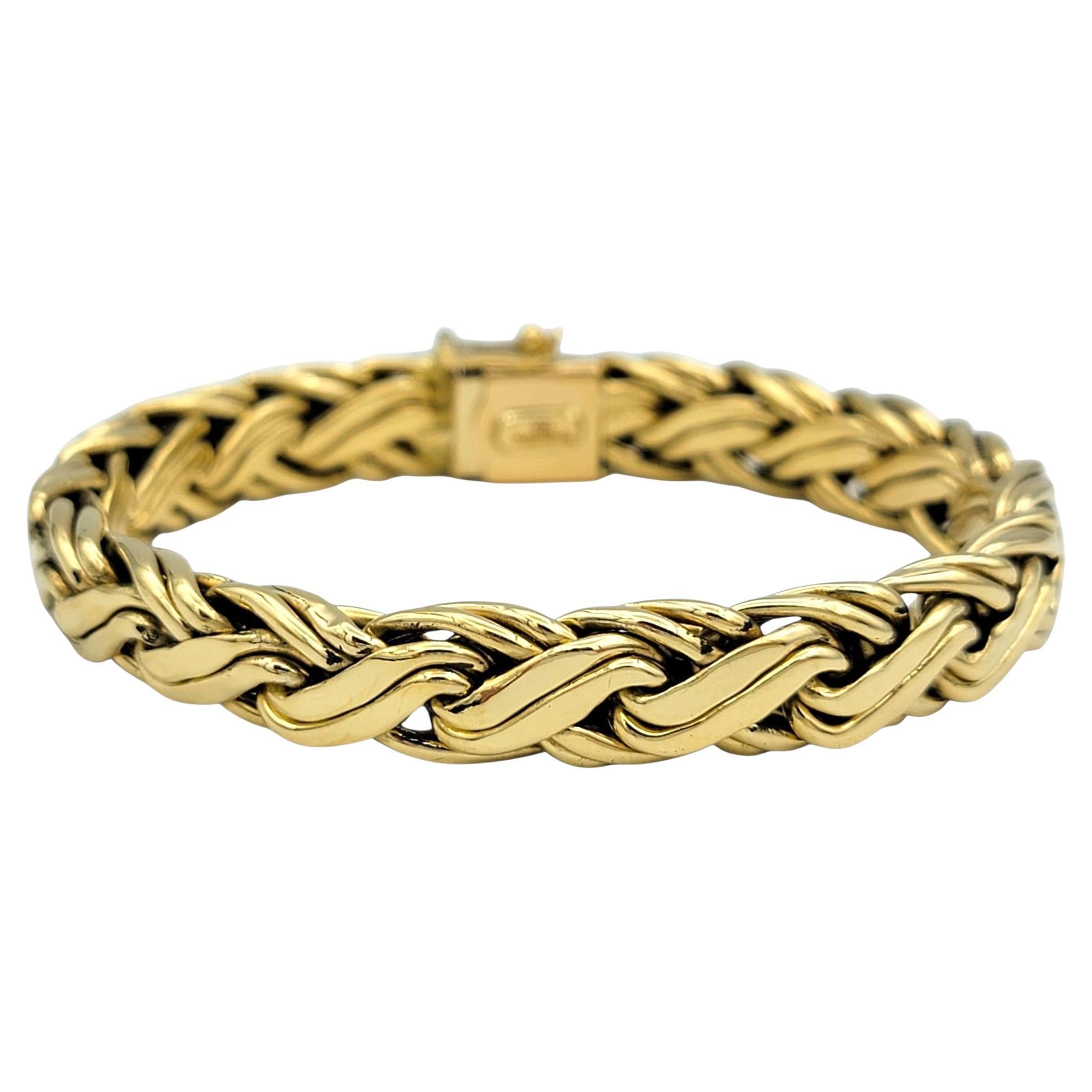 This authentic Tiffany & Co. bracelet features a rich Byzantine-style weave in glowing 18 karat yellow gold. Each link is meticulously interlaced to create a flexible, intricate texture that feels both regal and sculptural. The high polish finish