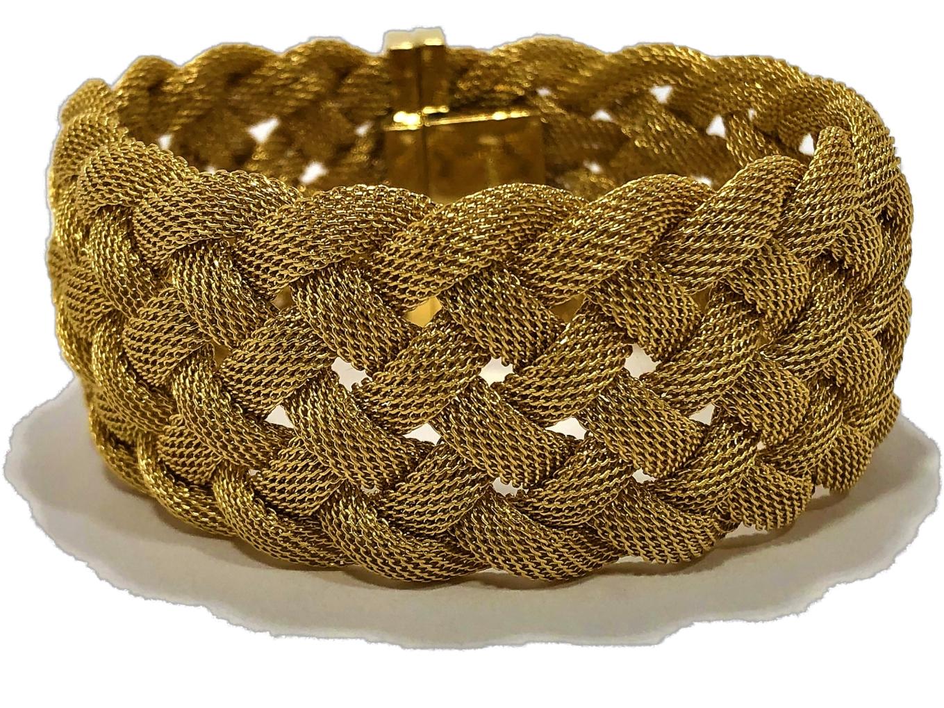 Made by Tiffany & Co late in the 20th Century, this 18K yellow gold mesh bracelet has a curved, bombee look to it. Rather than just laying flat, the 7 curved mesh strands, stand off the arm giving it a more substantial look and feeling. Measures 1