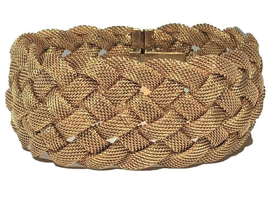 Made by Tiffany & Co late in the 20th Century, this 18K yellow gold mesh bracelet has a curved, bombee look to it. Rather than just laying flat, the 7 curved mesh strands, stand off the arm giving it a more substantial look and feeling. Measures 1