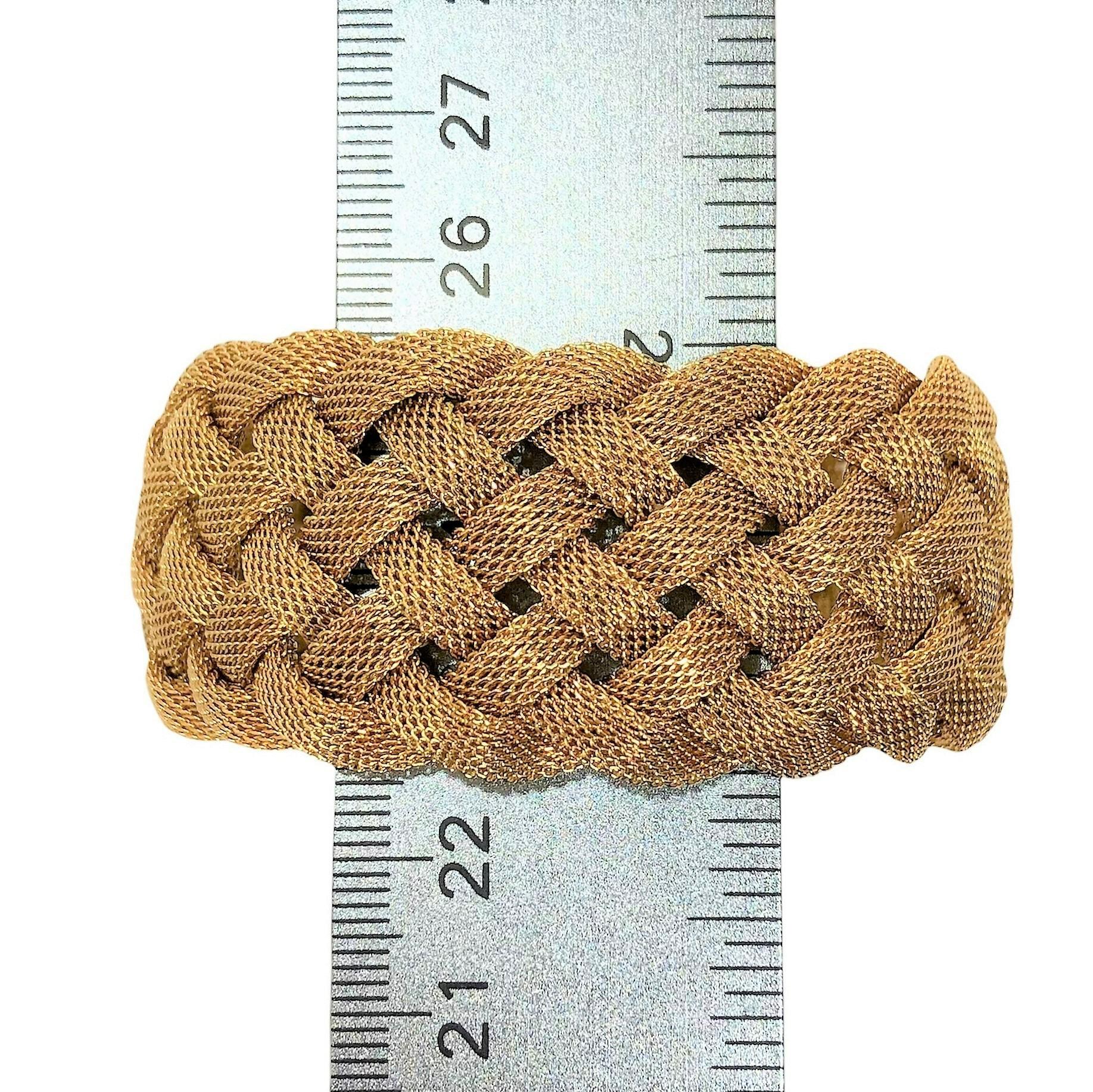 Made by Tiffany & Co late in the 20th Century, this 18K yellow gold mesh bracelet has a curved, bombee look to it. Rather than just laying flat, the 7 curved mesh strands, stand off the arm giving it a more substantial look and feeling. Measures 1