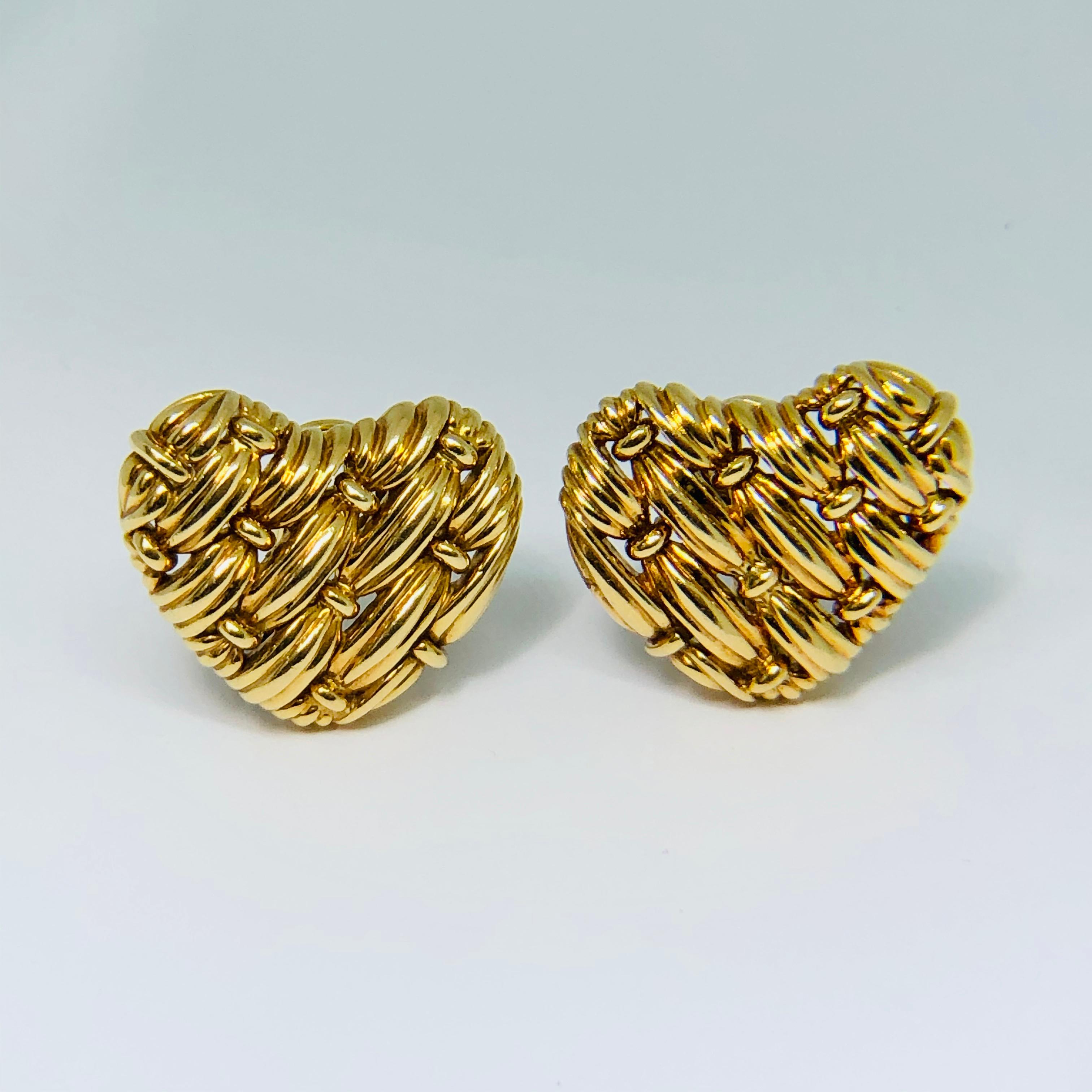 Textured 18ct woven gold heart shaped ear clips made, signed and numbered, part of the 'Signature Series' by TIFFANY & CO. Heavy gauge 18K yellow gold with a brilliant metallic foil weave finish. Clip backs, with attached comfort cushions.
About