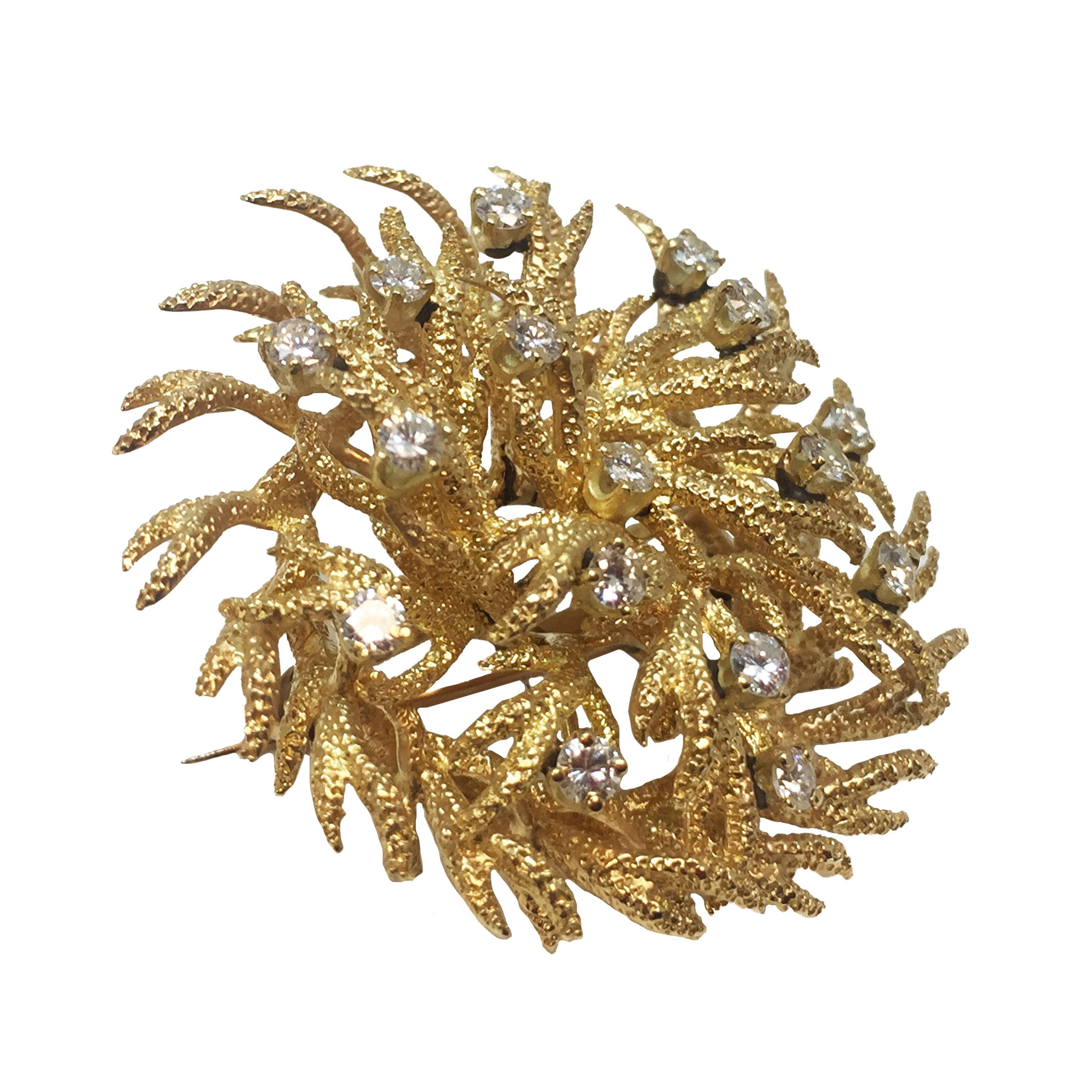 Circa 1970 Tiffany & Company 18K yellow Gold Brooch, all handmade, having a textured finish in the form of Branches. Set with Round Brilliant cut Diamonds that are F-G in color and VS in Clarity and total just under 1 Carat. The Brooch measures 1