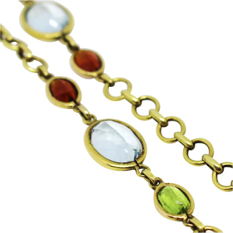 Circa 1970s Tiffany & Company 18K yellow Gold Long link chain Necklace, measuring 29 inches in length and having bezel set Gemstones, all of very fine color, Amethyst, Peridot, Garnet, Blue and Golden Topaz. The larger stones measure 10 X 8 MM
