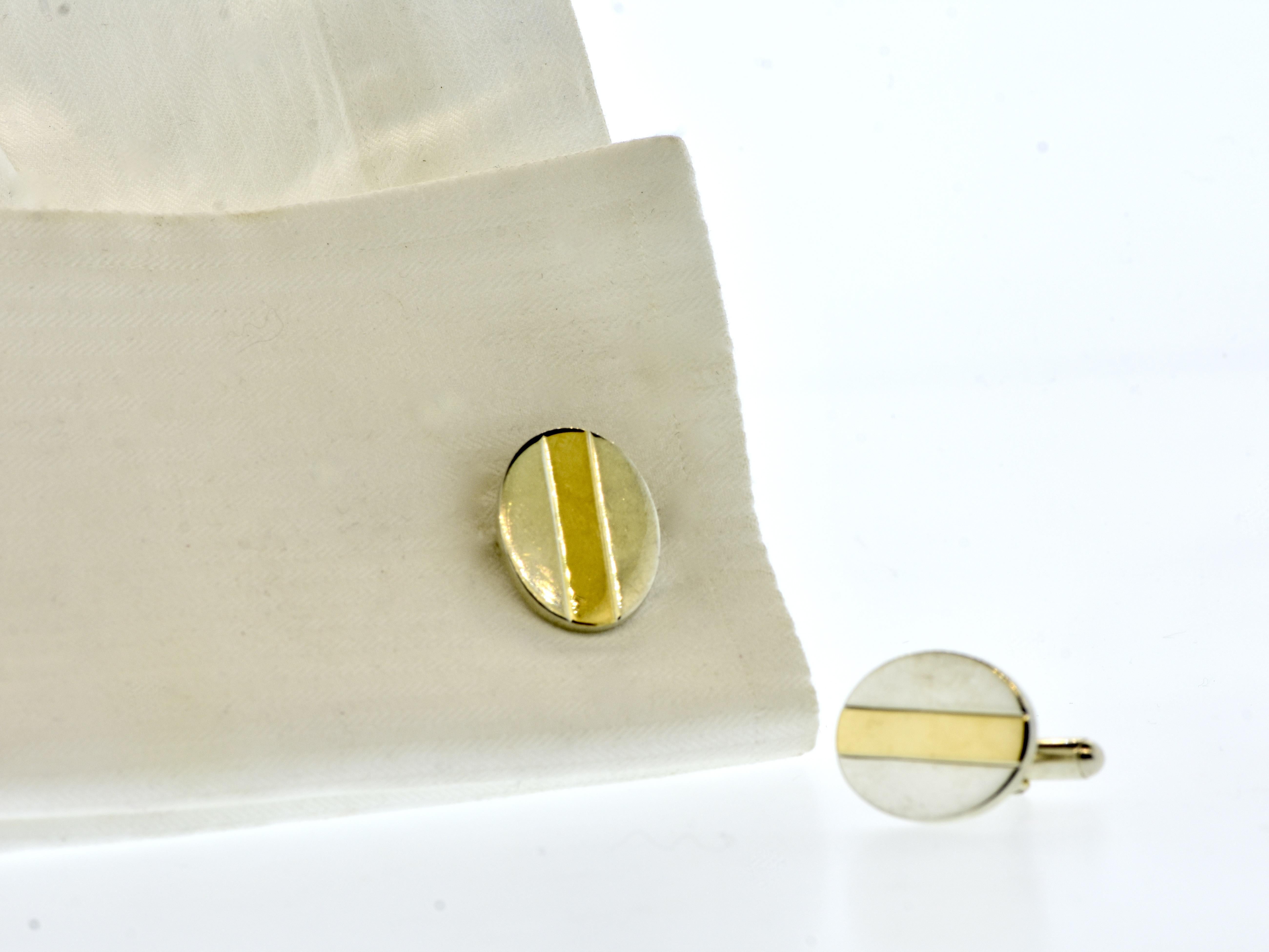 Tiffany & Co yellow gold and sterling silver vintage oval shaped cufflinks, c. 1990.  These cufflinks weigh 15.3 grams, they have a length of 13/16th of an inch, and a width of 10/16th of an inch.

In fine condition, these classic cufflinks are easy