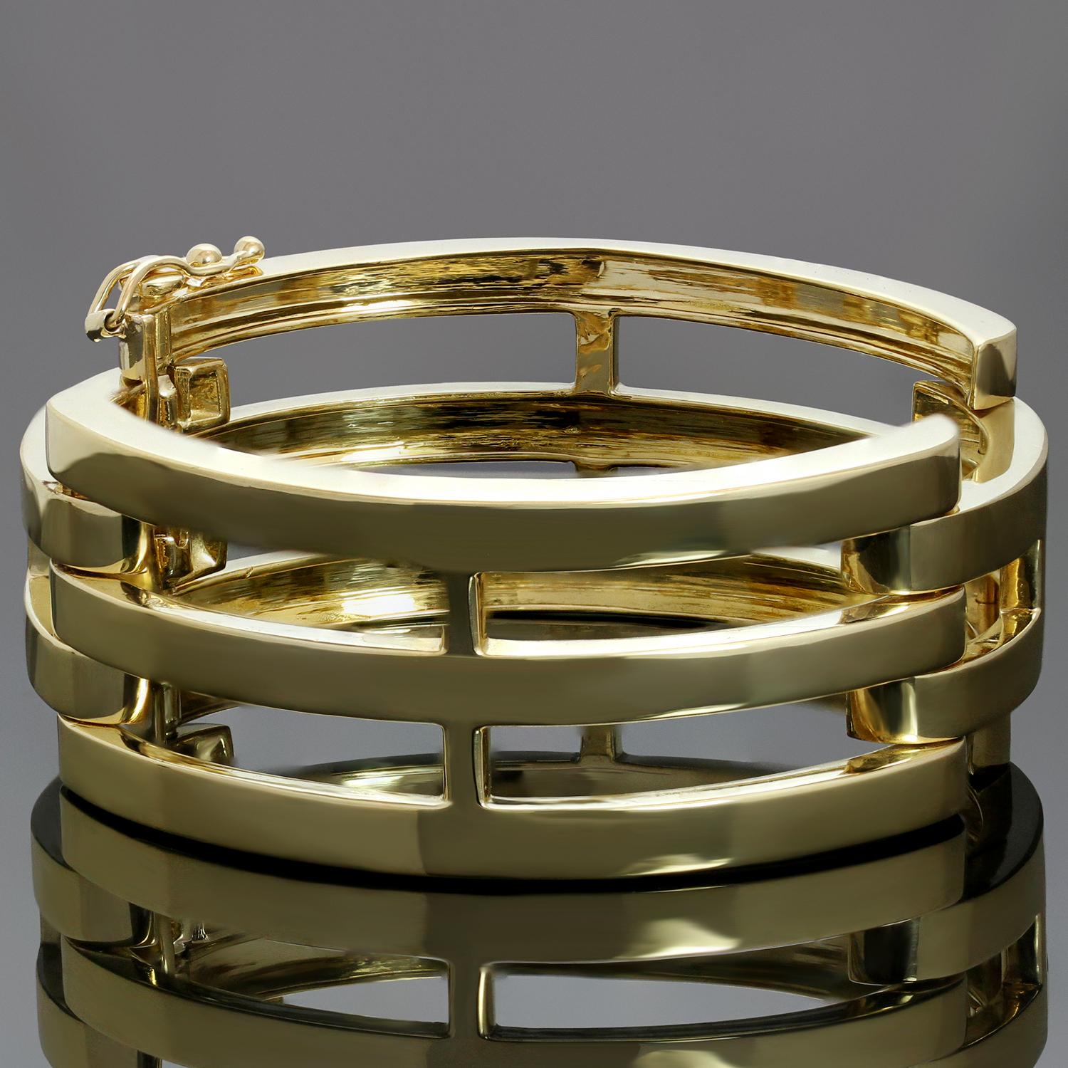 This elegant Tiffany & Co. bangle bracelet features a linked design crafted in 18k yellow gold. Made in United States circa 1990s. Measurements: 0.94