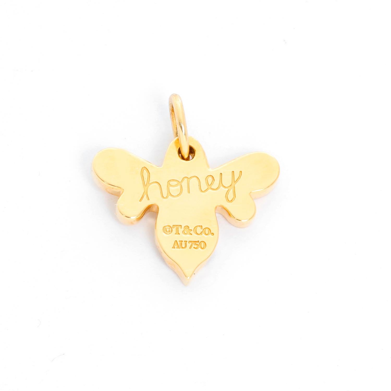 14k yellow gold bee charm with the word 