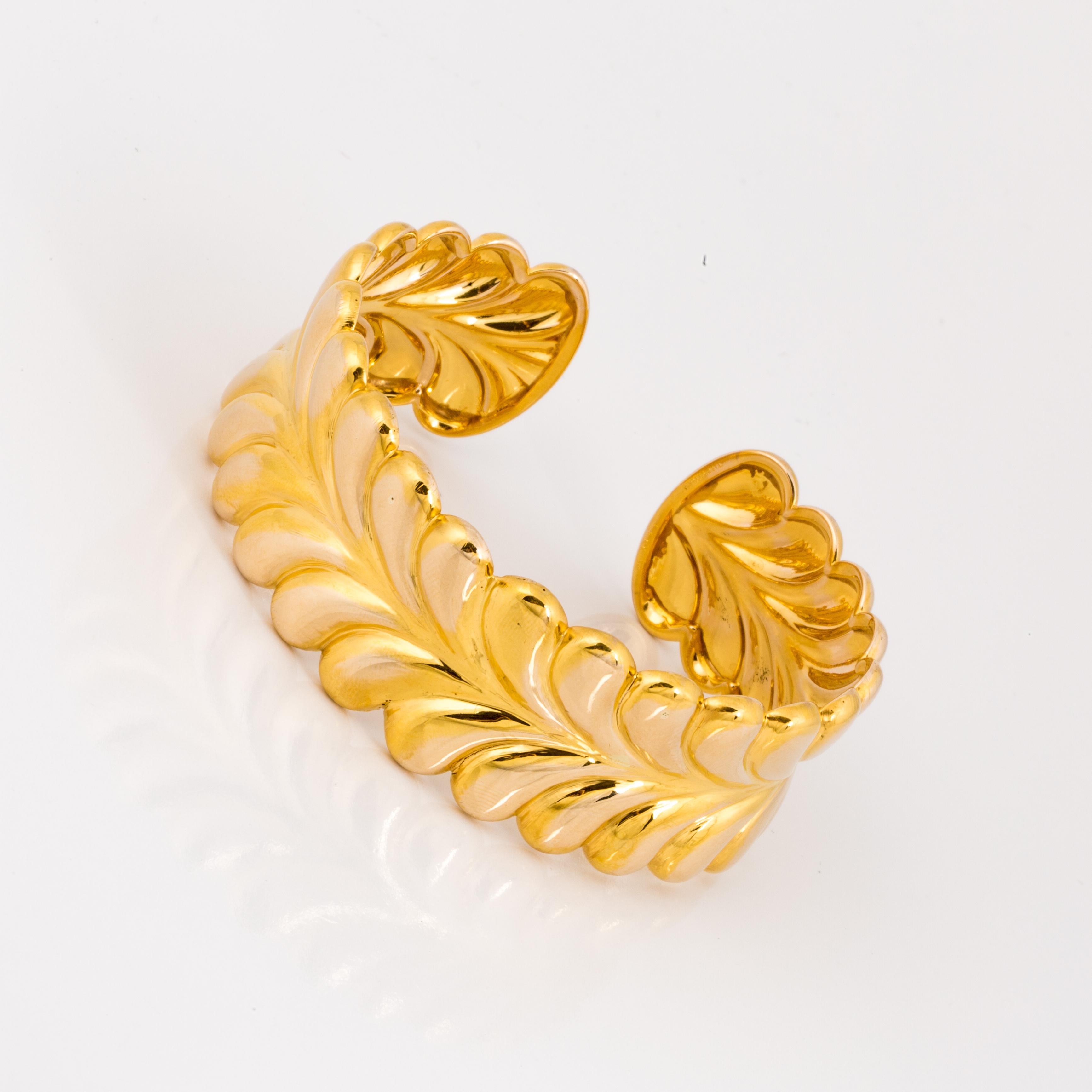 Tiffany & Co. 14K yellow gold cuff style bracelet with a gathered design.  It measures 1 inch in width and the oval opening is 2 1/2 inches.  