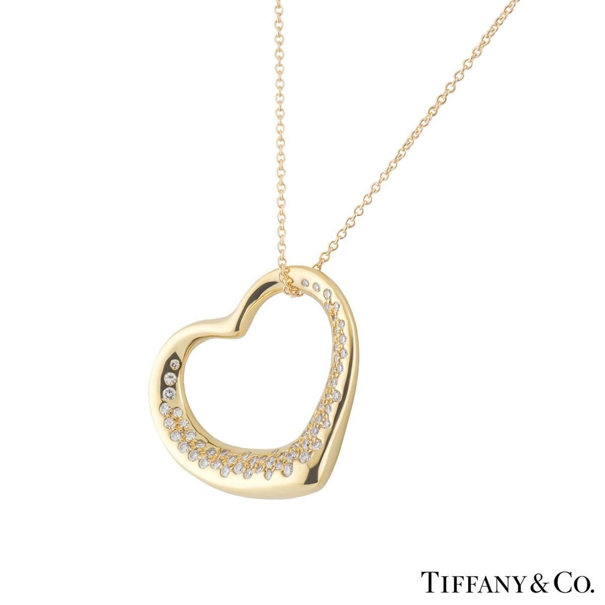 A beautiful 18k yellow gold diamond Tiffany & Co. heart necklace from the Elsa Peretti Open Hearts collection. The necklace comprises of an open work heart motif with round brilliant cut diamonds. The diamonds have a total weight of approximately
