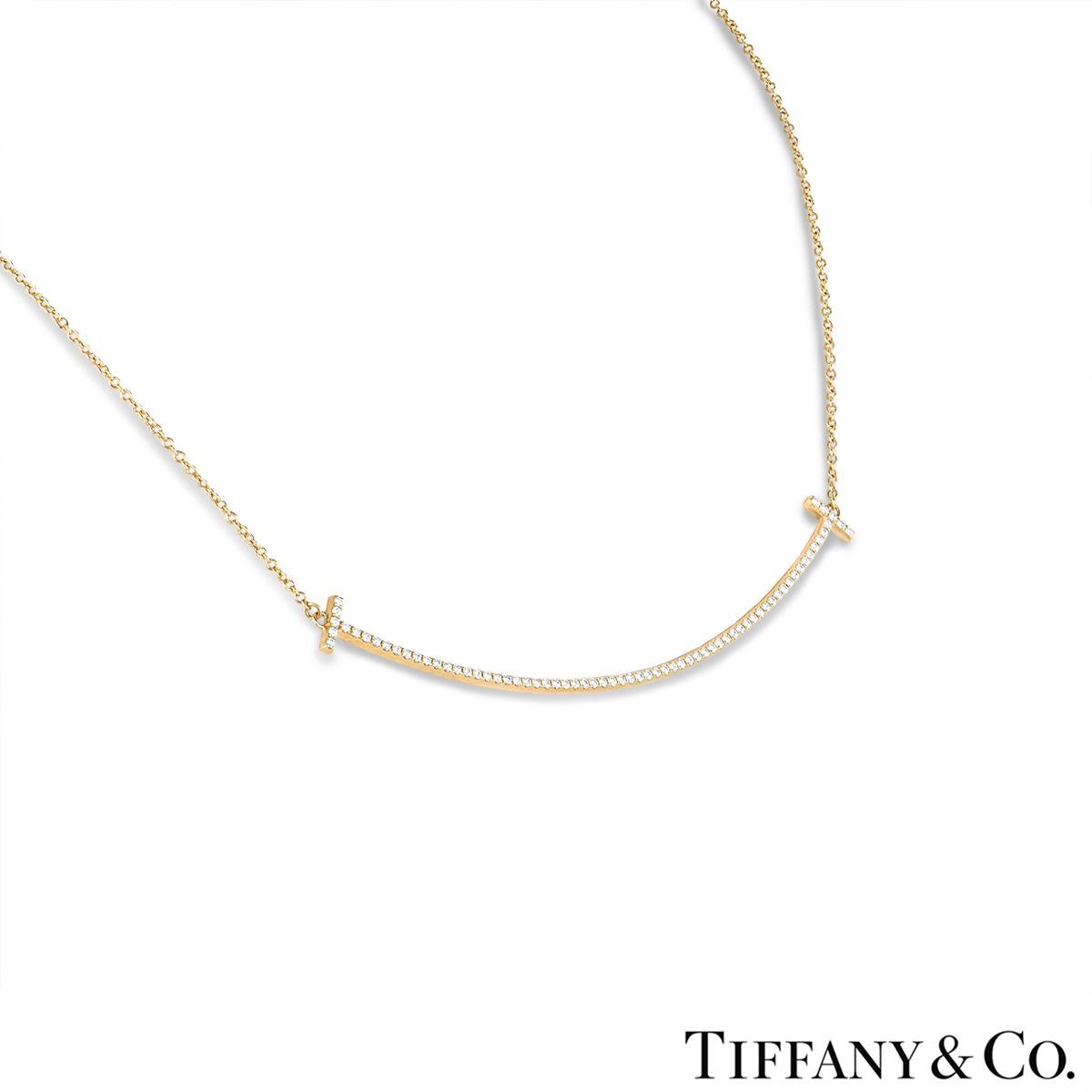 A charming 18k yellow gold diamond Tiffany & Co. pendant from the Tiffany T Smile collection. The pendant comprises of a smile motif pave set with 70 round brilliant cut diamonds with a total weight of 0.19ct, G+ colour and VS+ clarity. The pendant