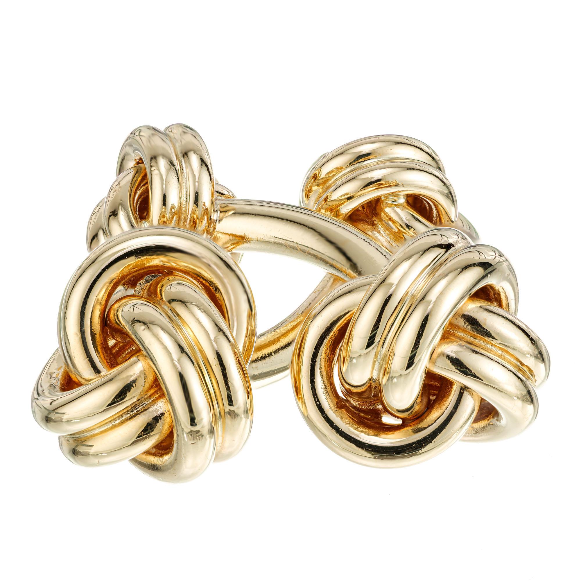 Tiffany & Co solid heavy double sided knot cufflinks. 14k yellow gold. Circa 1960's

14k yellow gold 
Stamped: 14k
Hallmark: Tiffany & Co 
21.3 grams
Top to bottom: 29.5mm or 1.1 Inch
Width: 10.2mm or .40 Inch
Width: 13.0mm or .50 Inch
Depth or