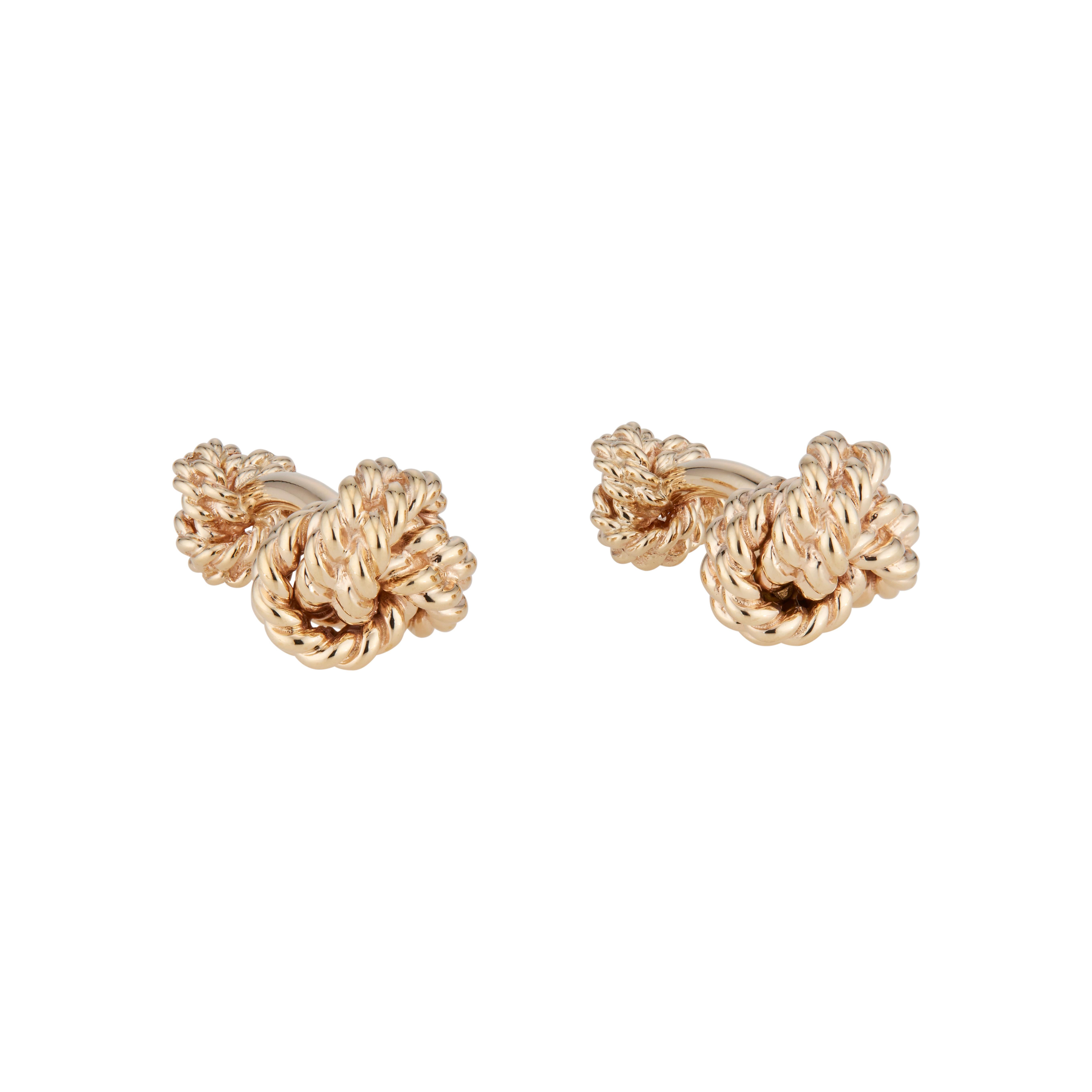 1970's Vintage Tiffany & Co heavy double sided knot cufflinks in 14k yellow gold. 

14k yellow gold 
Stamped: 14k
Hallmark: Tiffany + Co
27.7 grams
Top to bottom: 16mm or 5/8 Inch
Width: 16mm or 5/8 Inch
Depth or thickness: 11mm
