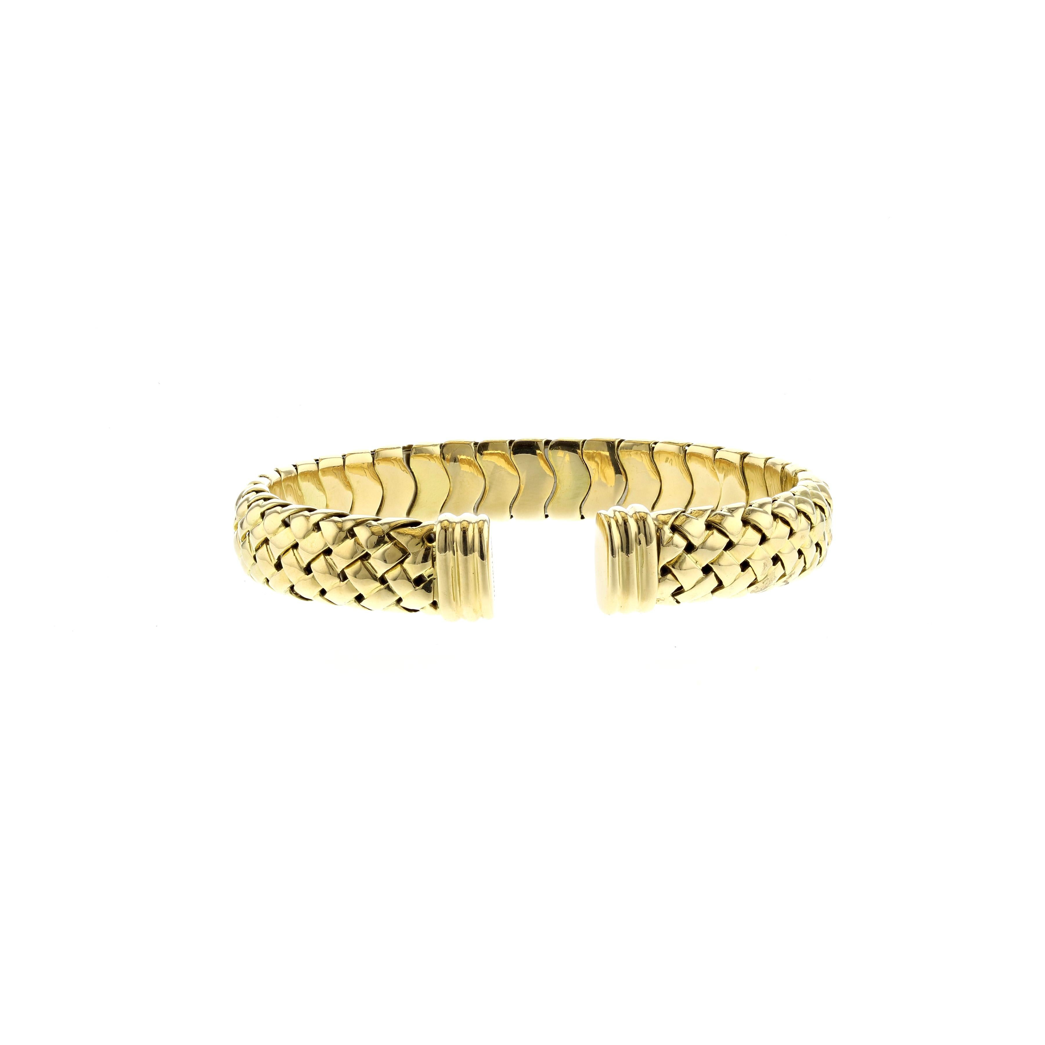 18K yellow gold cuff bracelet by Tiffany & Co.  It is a flexible cuff in a woven design.  Measures 3/8