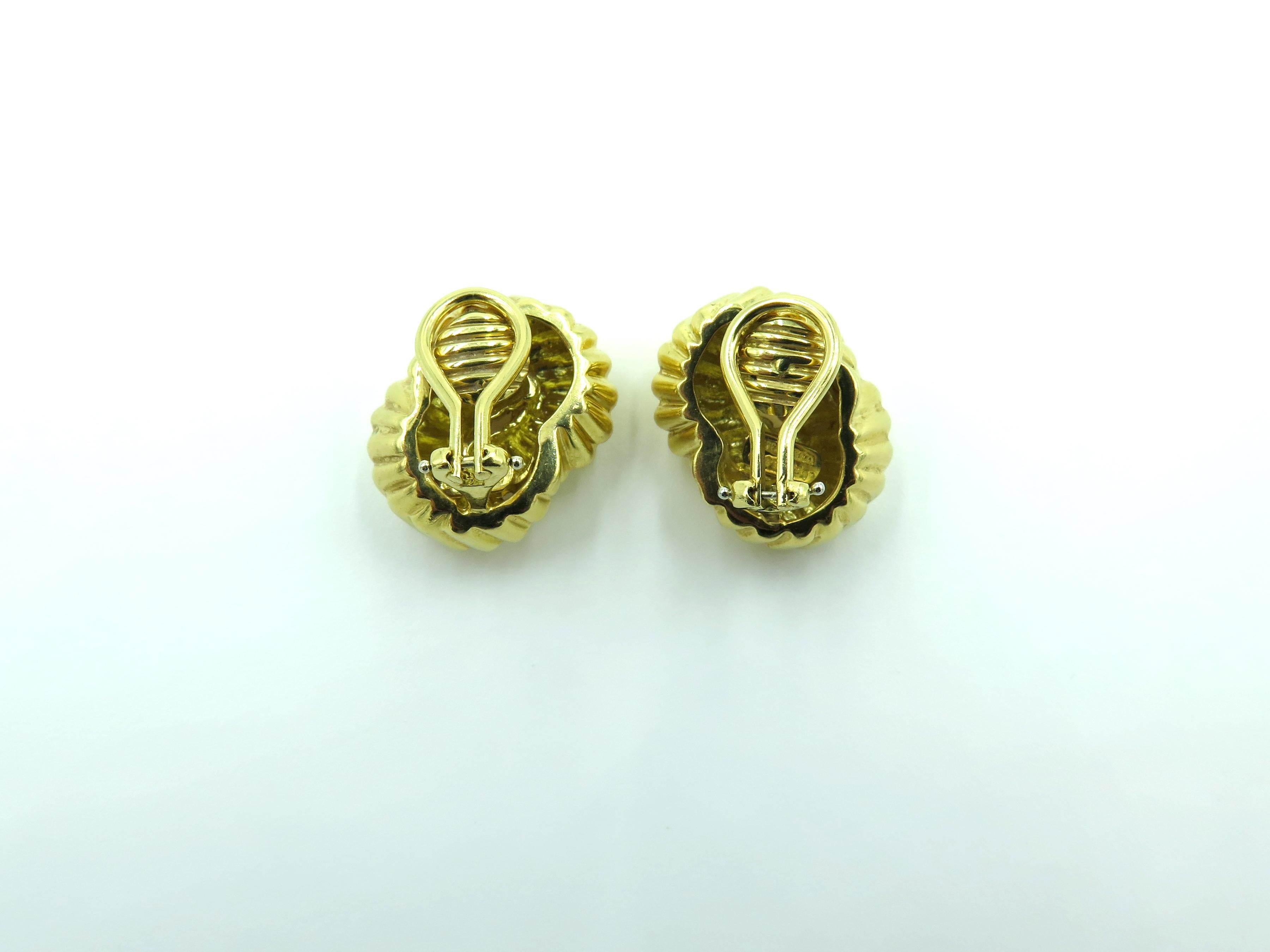 A pair of 18 karat yellow gold earrings. Tiffany & Co. Designed as a fluted knot. Length is approximately 3/4 inches, gross weight is approximately 20.3 grams. Stamped Tiffany & Co. 750, 1998.
