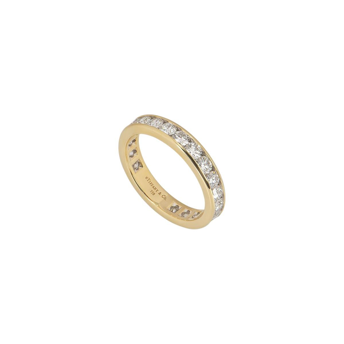 A stunning 18k yellow gold diamond ring by Tiffany & Co. from the Diamond Wedding Band collection. The ring is channel set with 22 iconic round brilliant cut diamonds, with a total weight of 1.89ct. The ring has a width of 3.9mm and is a size UK O½,