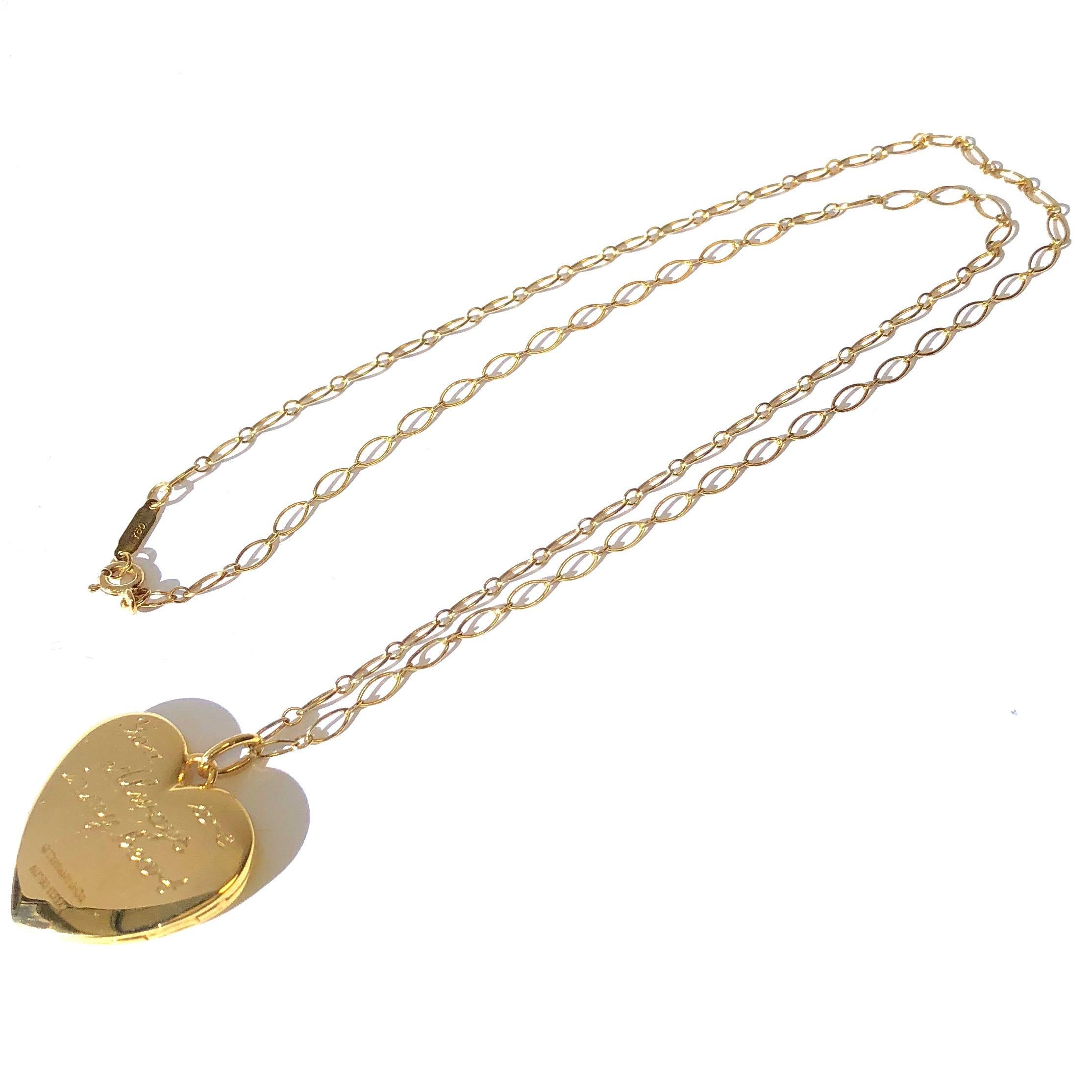 Tiifany & Co. 18K yellow gold heart locket pendant necklace. The locket is engraved 