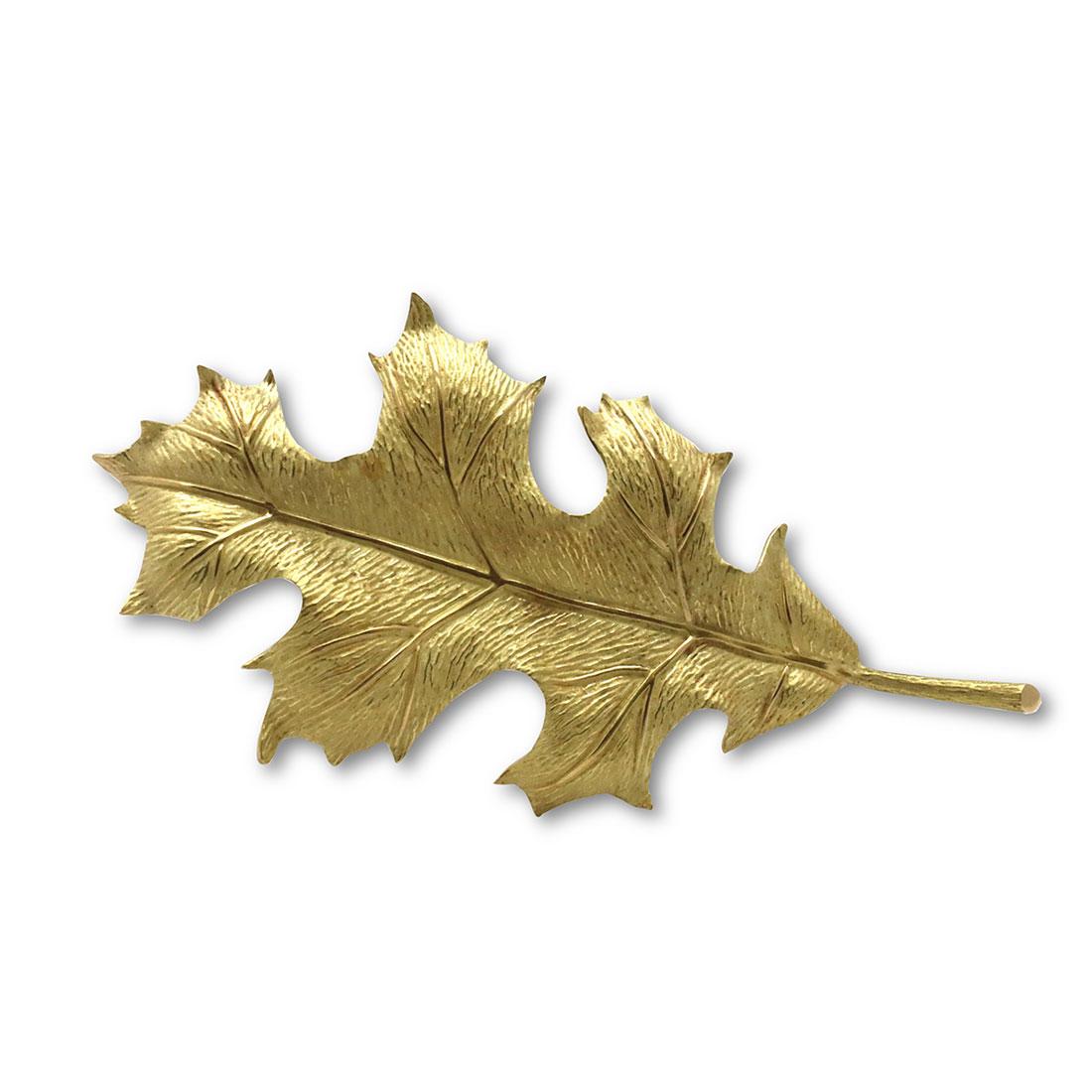 Authentic Tiffany & Co. brooch crafted in 18 karat yellow gold. This stunning brooch features a textured gold leaf design. At its widest points, the brooch measures 2.44 inches x 1.22 inches. Signed Tiffany & Co., 750. This brooch is not presented