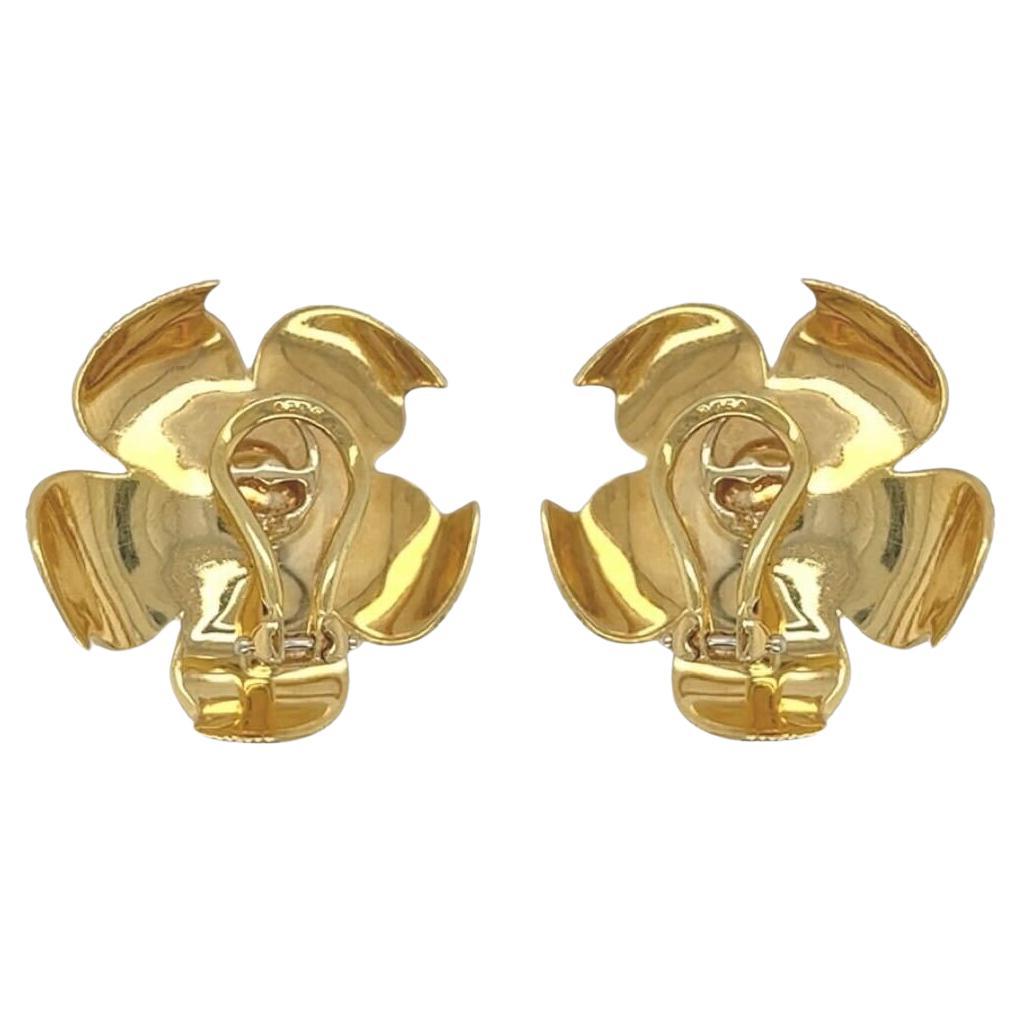 A pair of 18 karat yellow gold earclips, Tiffany & Co.  Each Magnolia earclip designed as a flower with five (5) striated petals centering a cluster of short gold rods culminating in beads.  Length approximately 1 inch.  Gross weight approximately