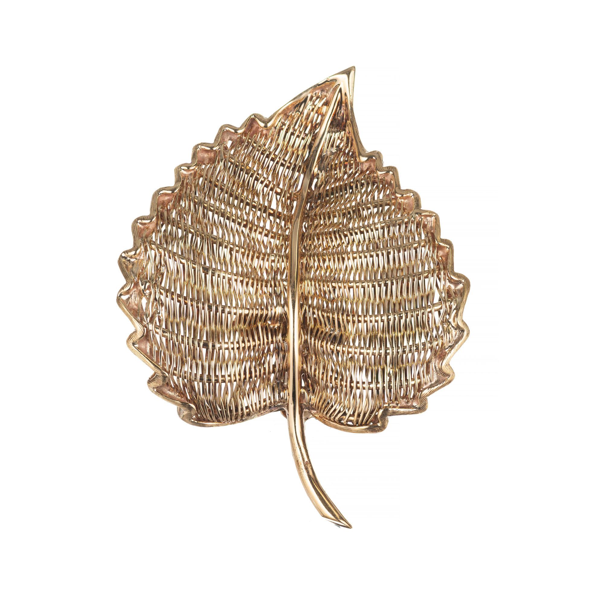  Tiffany & Co. yellow gold woven wire leaf brooch. Woven front and back to create the leaf design. Signed Tiffany & Co Italy, 18k. Circa 1950-1960.

18k Yellow Gold
Stamped 18k Tiffany + Co Italy
9.9 grams
1 7/8 x 1 3/8 inches.