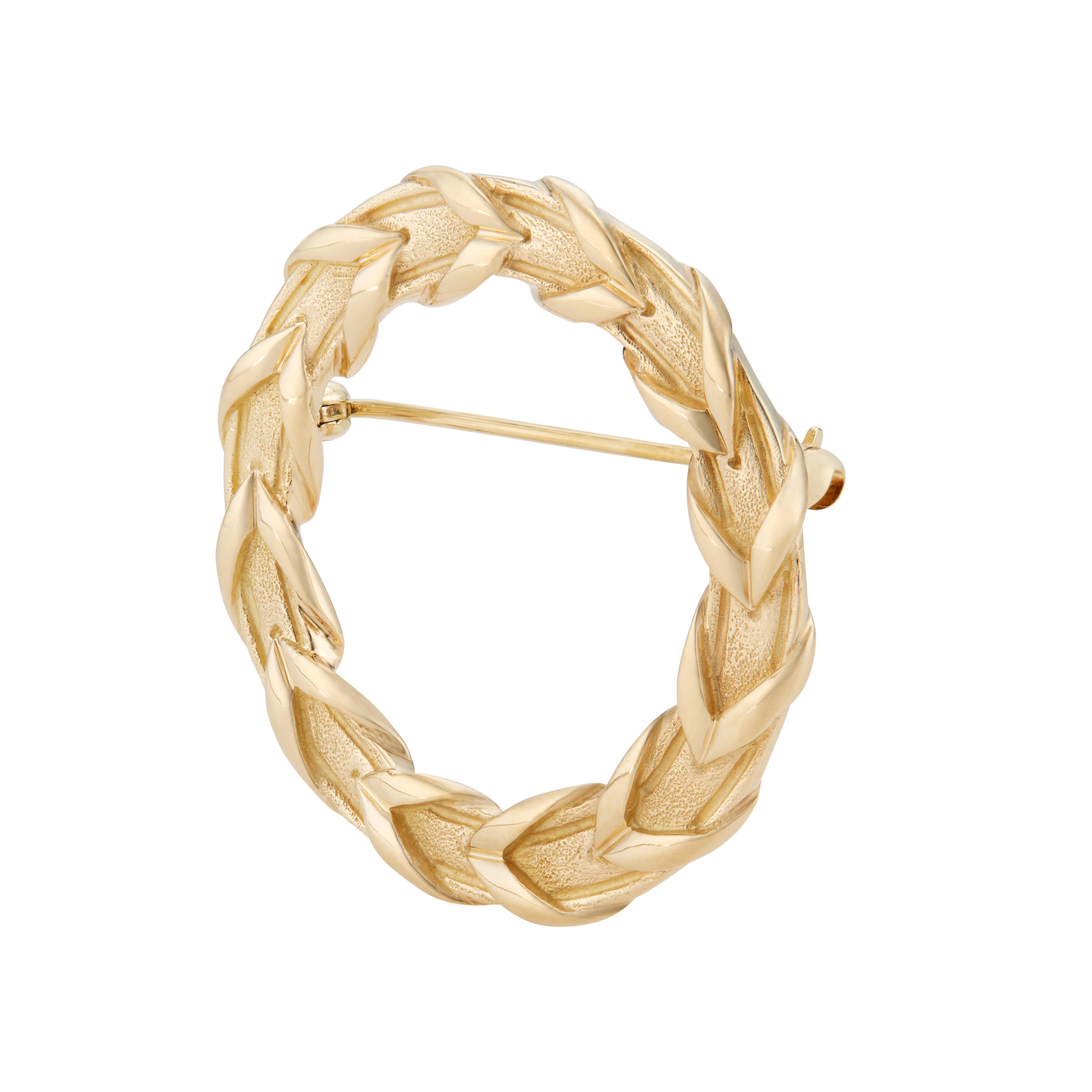 Tiffany & Co open circle 18k yellow gold wreath brooch.

18k yellow gold 
Stamped: 750
Hallmark: T+ Co 1983
10.5 grams
Top to bottom: 33.8mm or 1 1/3 Inch
Width: 34mm or 1 1/3 Inch
Depth or thickness: 2.5mm
