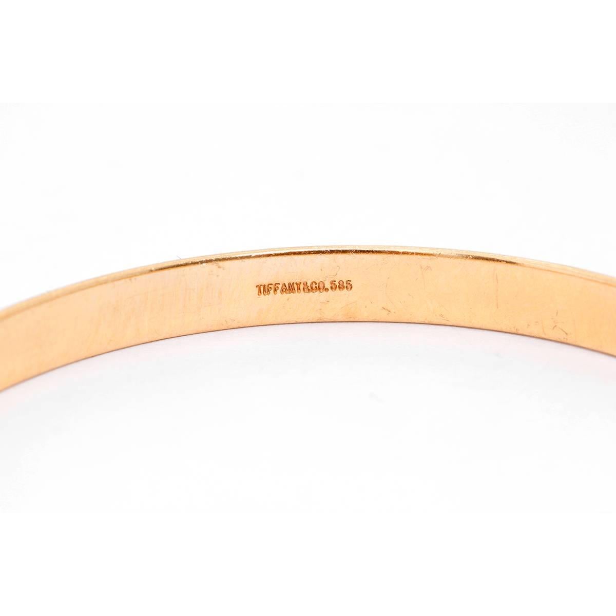 Tiffany & Co. 14K Yellow Gold Oval Bangle Size 6 3/4 - . Pre-owned with custom box.  Size 6 3/4. Hallmarks Tiffany & Co., 585. Total weight 8 grams.