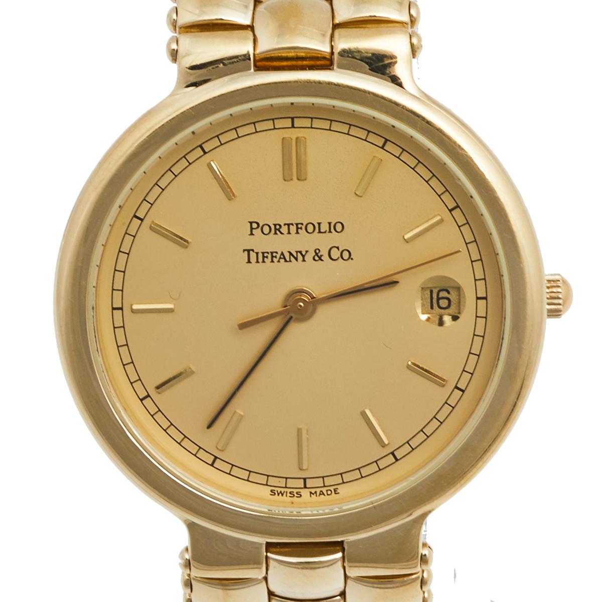 Here we have a watch called 'Portfolio' from a brand revered by luxury lovers for decades. It arrives in a gold-plated stainless steel body with a round case. On the case is a smooth dial that has stick hour markers, minute markers around the outer
