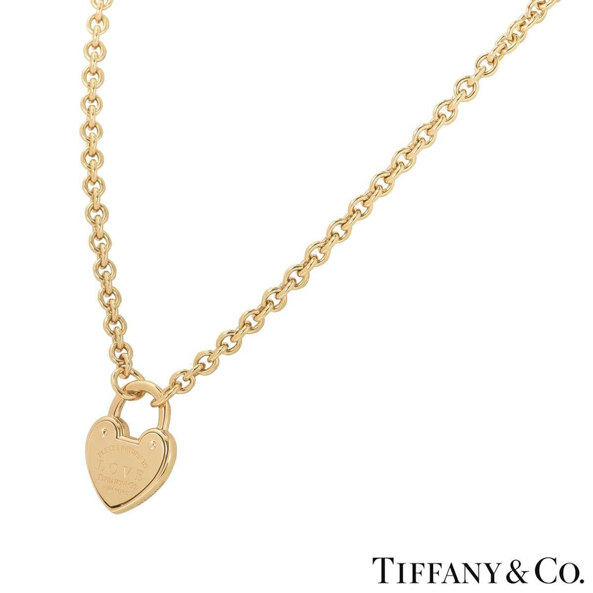 An 18k yellow gold necklace by Tiffany & Co. from the Return to Tiffany collection. The heart tag is in a padlock style engraved in the centre with the infamous 'Return to LOVE' inscription on both sides of the motif. The necklace has a length of