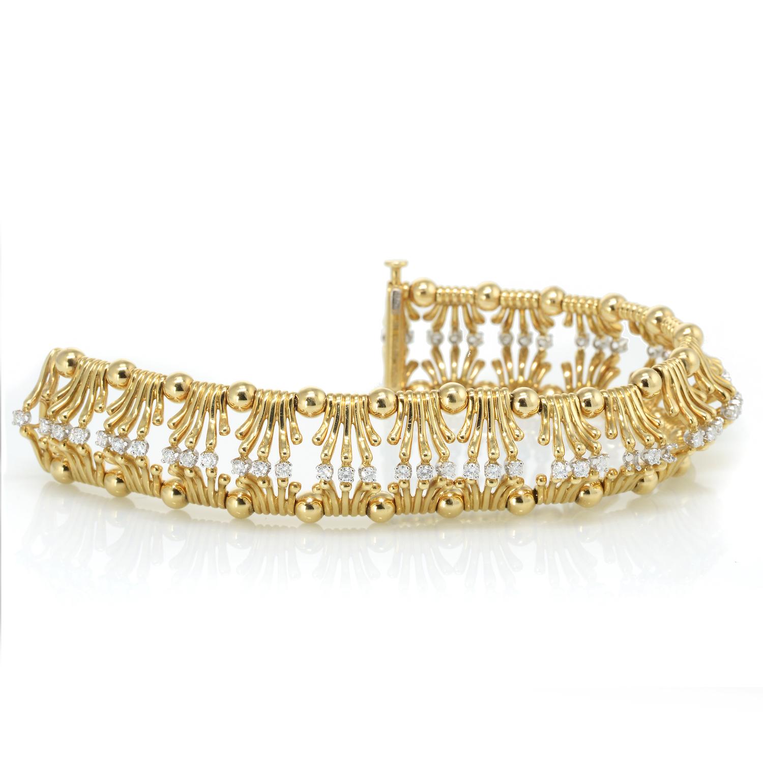 TIFFANY & CO. JEAN SCHLUMBERGER DIAMOND AND GOLD BRACELET
Designed as an openwork band of sculpted gold links, with a line of diamonds in the center of the bracelet. 

Metal: 18K and platinum
Diamonds: 51 round diamonds approximate total weight of 2