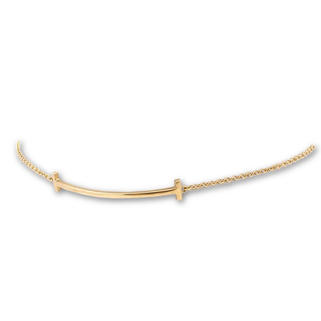 Authentic Tiffany & Co. 18 karat yellow gold 'smile' bracelet from the Tiffany T collection. A timeless design that is a tribute to the world's most universal gesture, the smile. The bracelet 6 3/4 inches in length and it will fit up to size 6.