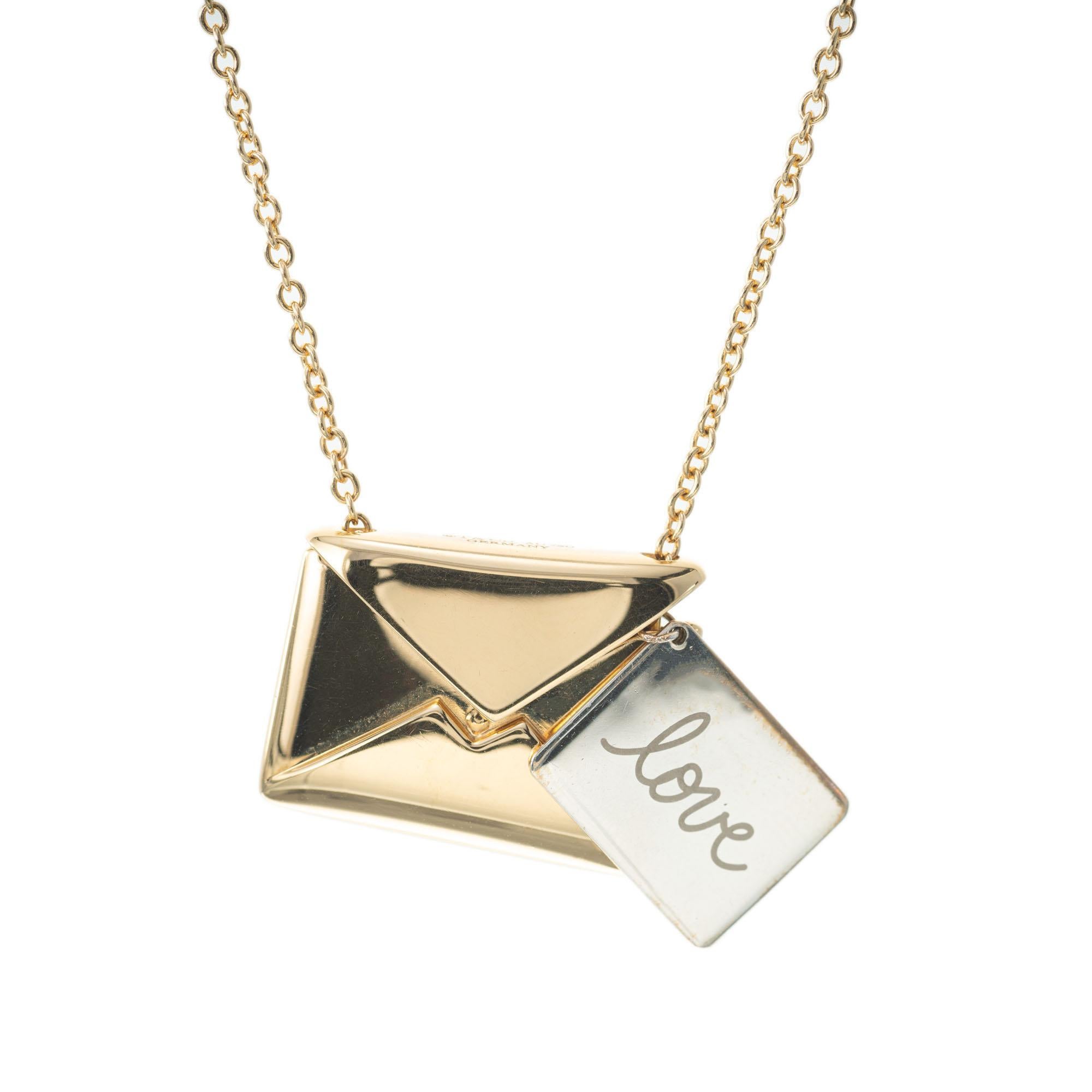 Tiffany & Co sweet nothing envelope necklace in 18k yellow gold. The top of the envelope opens with sterling silver “LOVE” note inside. Hallmark on back of envelope, on top of the envelope, on love note and on clasp tag. Tiffany box and pouch