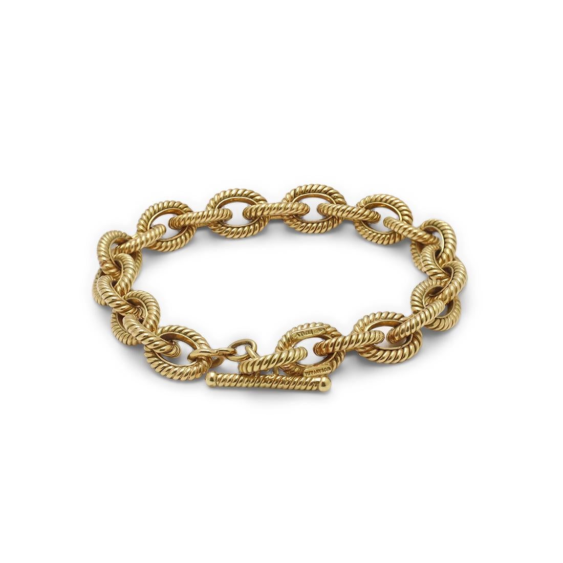 Authentic Tiffany & Co. rope-textured oval link toggle bracelet crafted in 18 karat yellow gold. The bracelet measures 7 1/4 in length and 10mm in width. Signed Tiffany & Co., 750, Italy. The bracelet is not presented with the original papers or