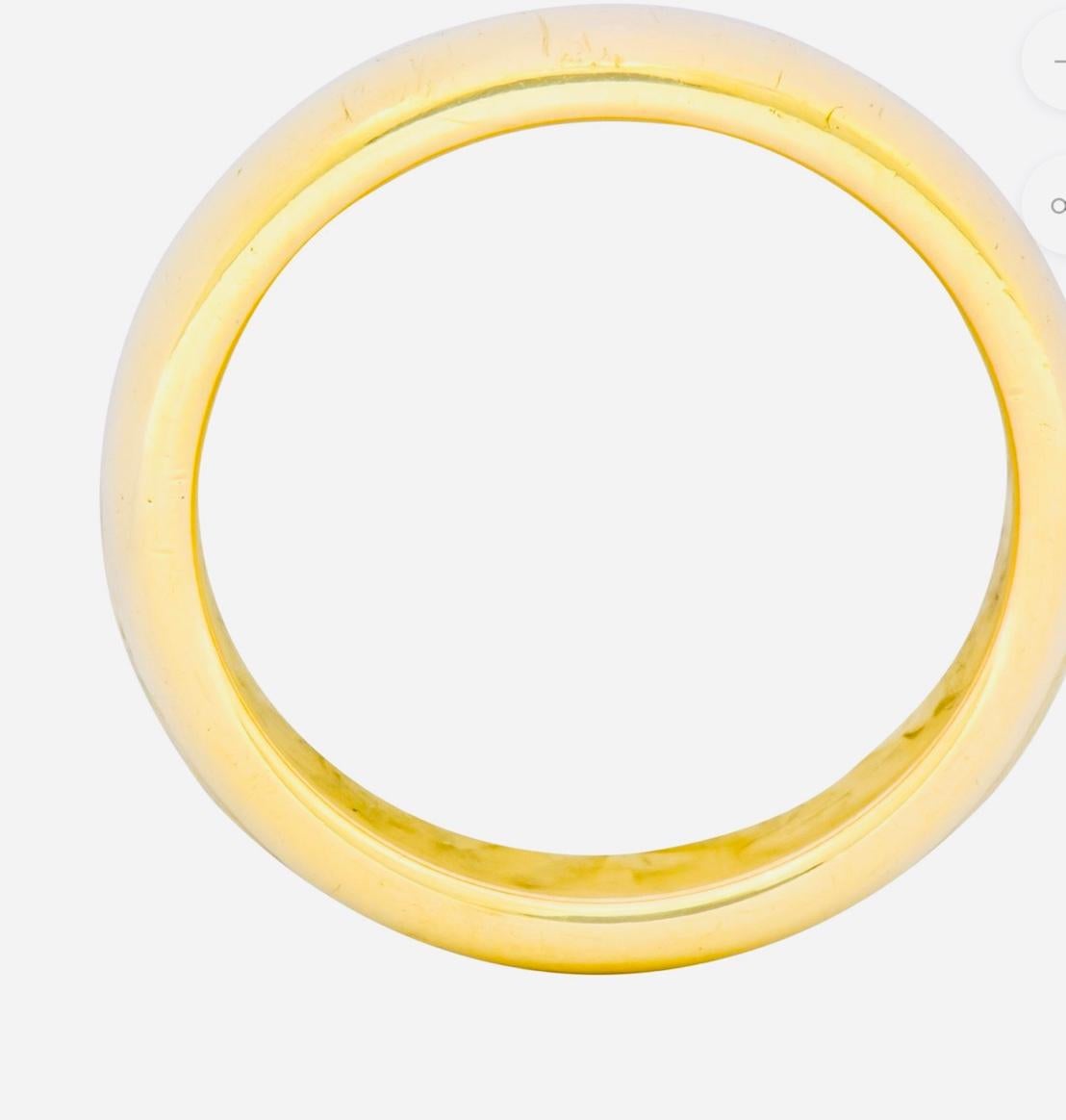 Tiffany & Co. Yellow Gold Wide Plain Wedding Band Ring, Estate
From the house of Tiffany & Co. this men’s wedding band, crafted in 18 karat yellow gold , measures 4.15 mm in width and  2.1 mm thick . It  is a size 9.25. It weighs 8.5 grams.
This is