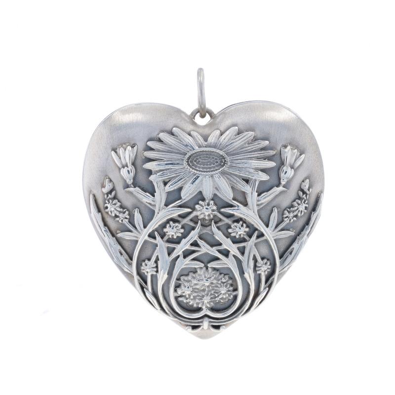 Brand: Tiffany & Co.
Collection: Ziegfeld
Design:  Daisy

Metal Content: Sterling Silver

Style: Large Locket
Theme: Floral Heart, Love
Features: Smooth & Brushed Finishes

Measurements

Tall: 1 3/4