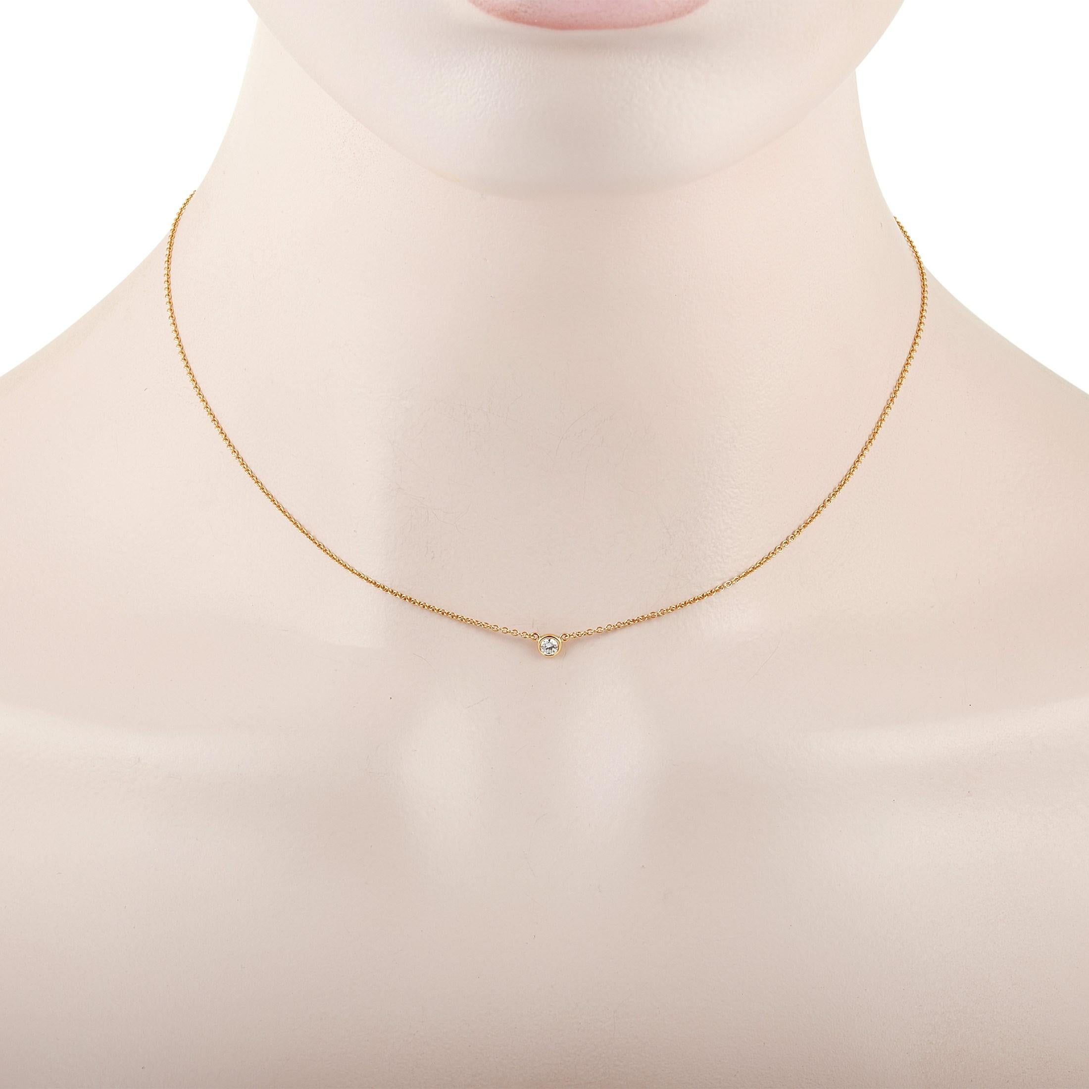 This classic Tiffany & Co. 18K Yellow Gold 0.08 ct Diamond necklace is made with 18K yellow gold and features a solitary 0.08 carat bezel-set diamond pendant. The delicate 18K Yellow Gold Chain measures 15 inches in length and features a spring-ring
