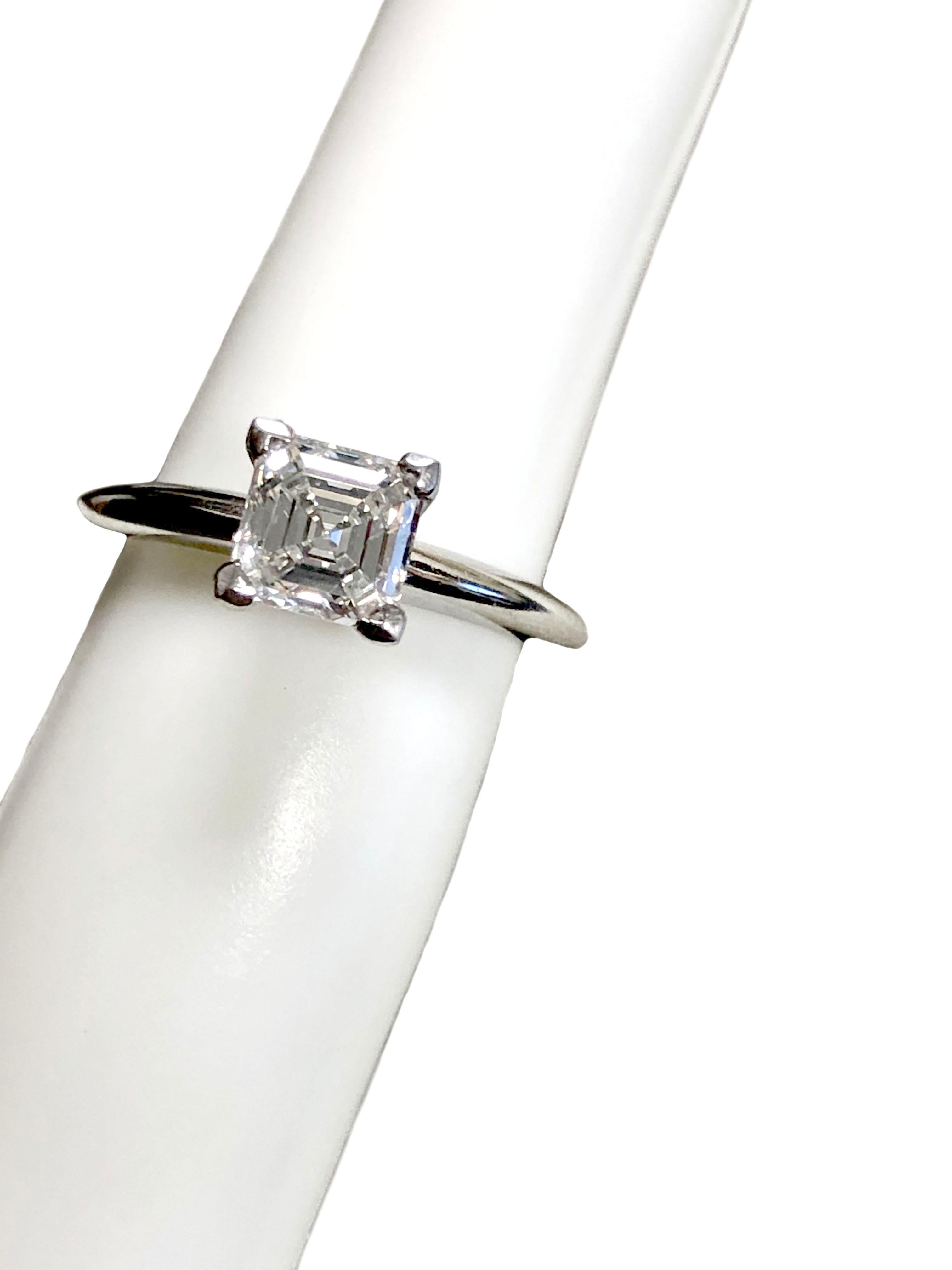  Tiffany & Company Engagement Ring, 2 M.M. wide Platinum mounting with a 4 prong head, set with a 1 Carat Square Emerald cut Diamond G.I.A. graded as G in color and VVS1 in clarity. Finger size 4 1/2 this ring is new unworn, comes in the original