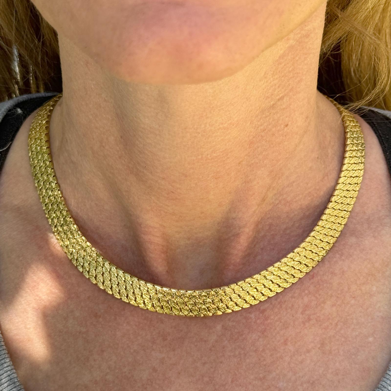 A vintage Tiffany & Co. 18 karat yellow gold textured collar necklace made in Germany is a luxurious and timeless piece of jewelry, blending Tiffany's renowned craftsmanship with German precision and quality. This necklace features a design crafted
