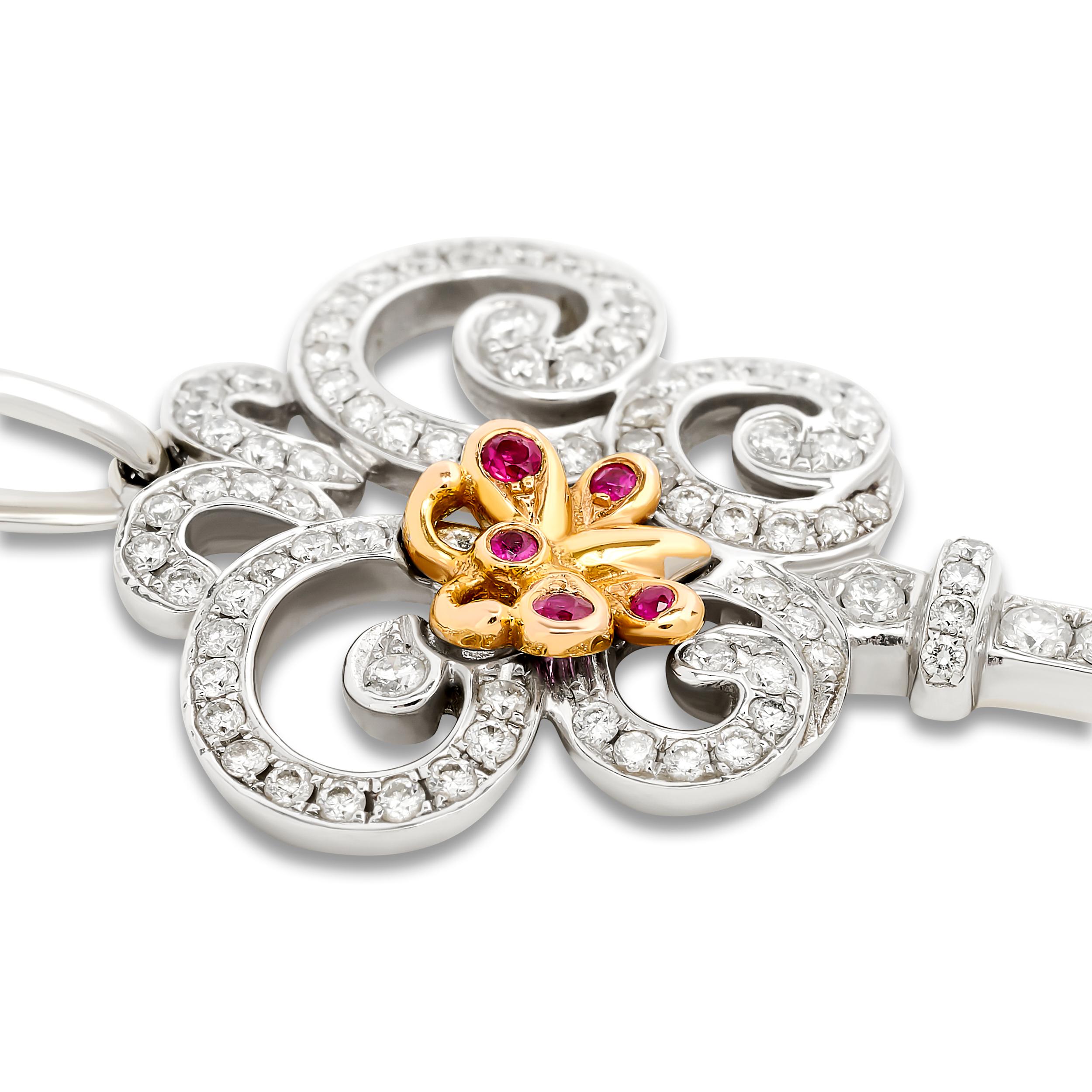 This Tiffany & Co. key pendant from the Tiffany Keys collection, features a diamond-pavé key shape with a scrolled bow, and a colorful central butterfly motif accented with rubies.

The total diamond weight is approximately 0.92 carat; the diamonds