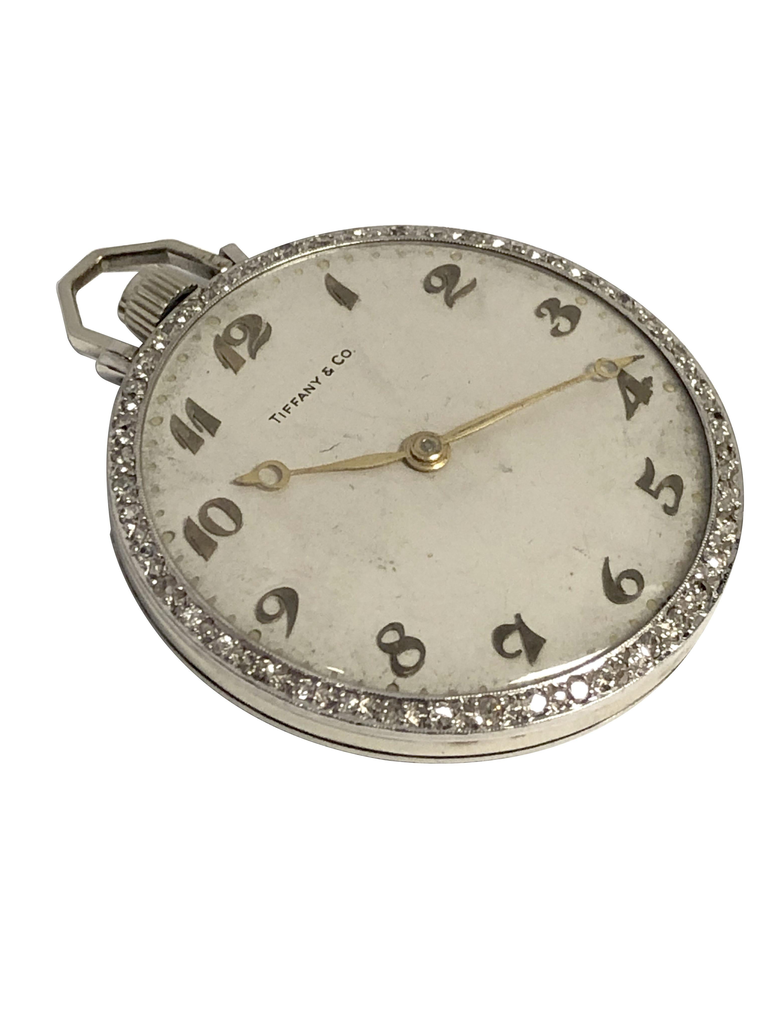 Circa 1930s Tiffany & Company Gents Pocket Watch, 41 M.M. 2 piece Platinum case with Diamond set bezel totaling approximately 1 Carat.  Sandoz Watch Co. of Switzerland 17 Jewel Mechanical, Manual wind movement. Original Silver Satin Dial with Raised