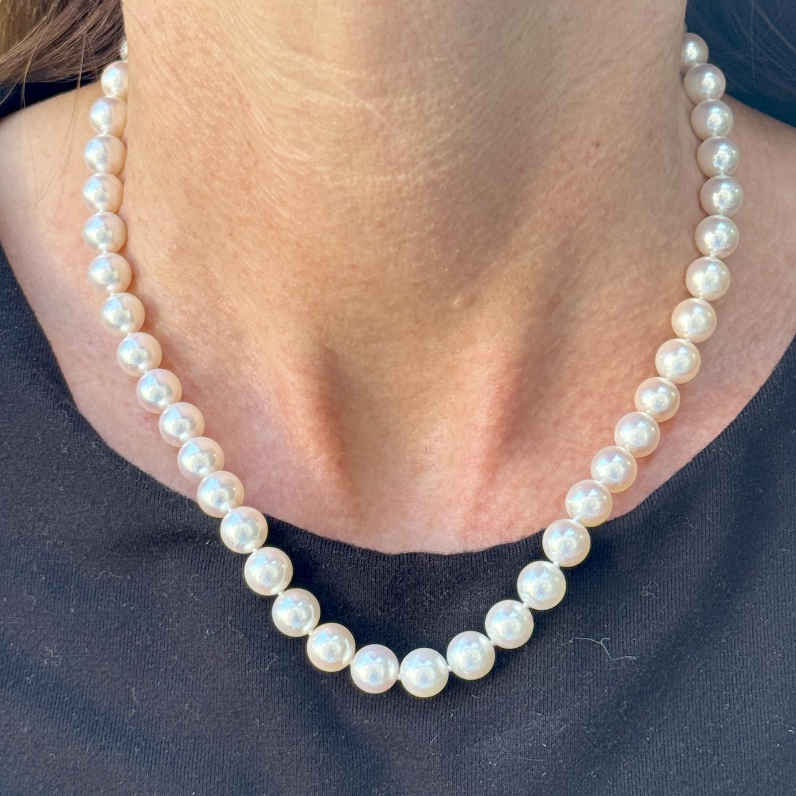 This elegant Tiffany & Co. Akoya Essential Cultured Pearl Necklace features luminous 8mm Akoya pearls, each hand-knotted on silk for timeless sophistication. Measuring 16 inches in length, it is finished with a distinctive Tiffany & Co. “X” clasp in