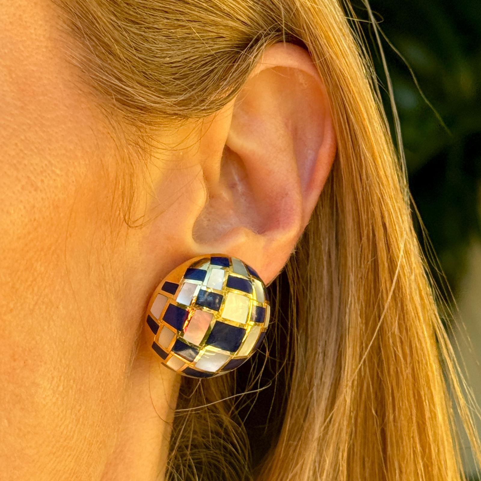 Iconic mother of pearl and lapis lazuli earrings by Angela Cummings for Tiffany & Co. The earrings feature inlays of mother of pearl and lapiz lazuli gemstone in a checkerboard pattern. The round earrings measure approximately  25 x 25mm and clip-on