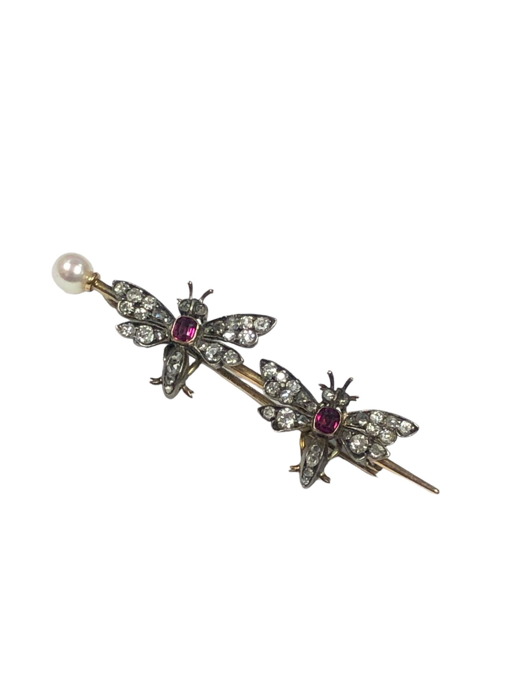 Circa 1900 Tiffany & Company Double Butterfly Brooch, measuring 2 1/4 inches in length.  Silver top and 14k Gold back, set with old Mine and Rose cut Diamonds totaling approximately .60 Carats, further set with Fine color old cut Cushion Rubies and