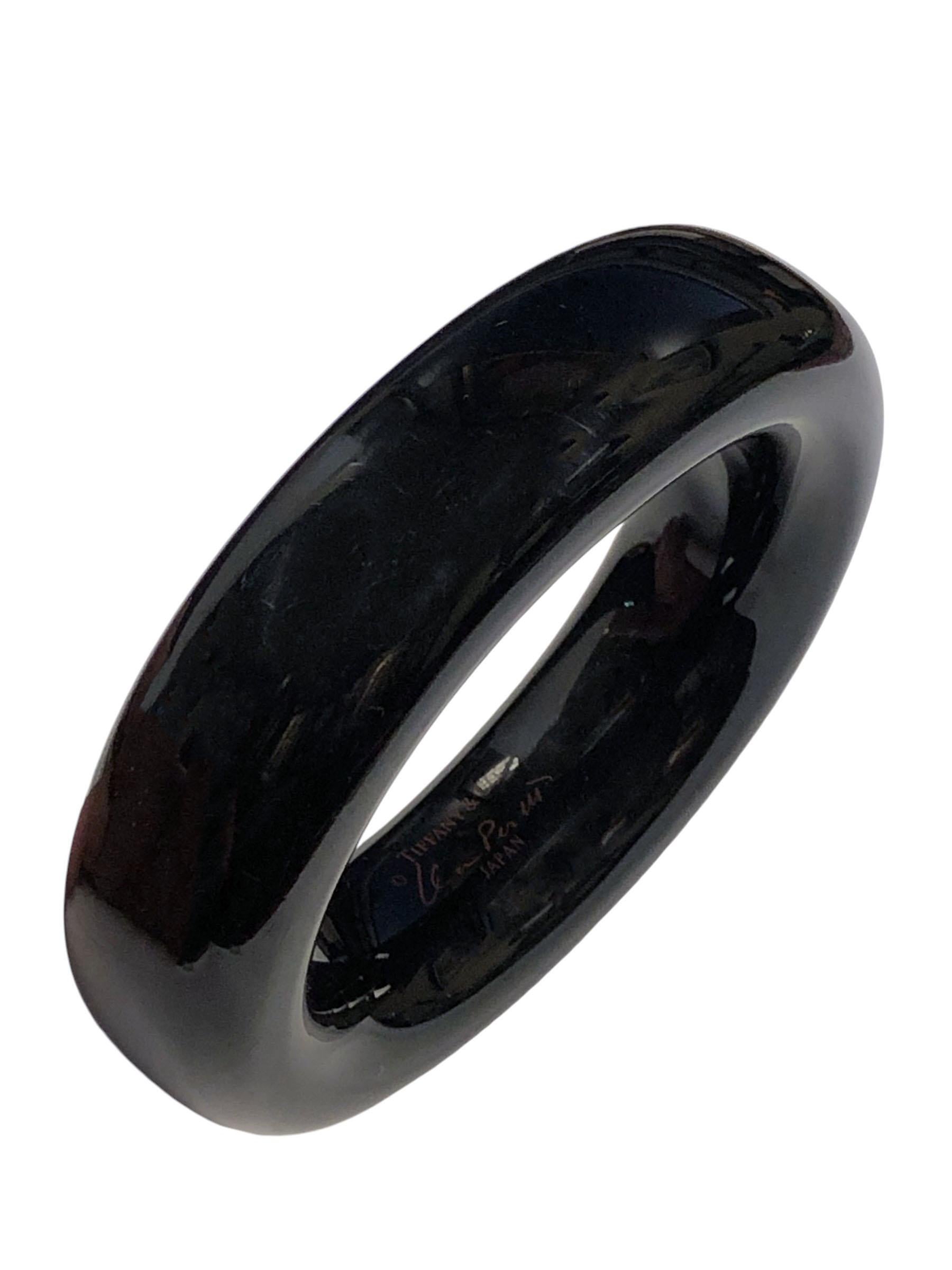 Circa 1990 Elsa Peretti for Tiffany & Company Black Resin Bangle Bracelet, Measuring 7/8 inch wide and having an inside measurement of 7 inches. Comes in original Tiffany Suede pouch.
