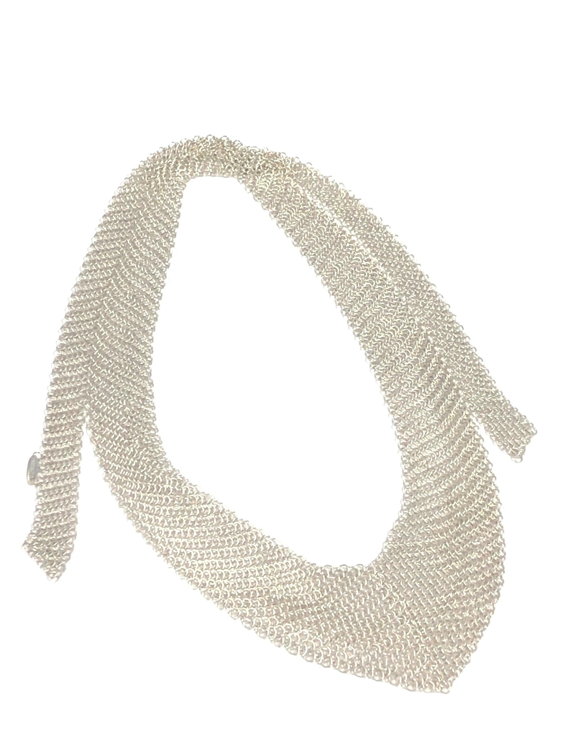 Circa 1990 Elsa Peretti for Tiffany & Company Mesh Bib Necklace, measuring 25 1/2 inches in length, 1 1/2 inches wide at the bottom and tapering to 3/8 inch at the end. This necklace ties at the back to secure it and is in Excellent unworn