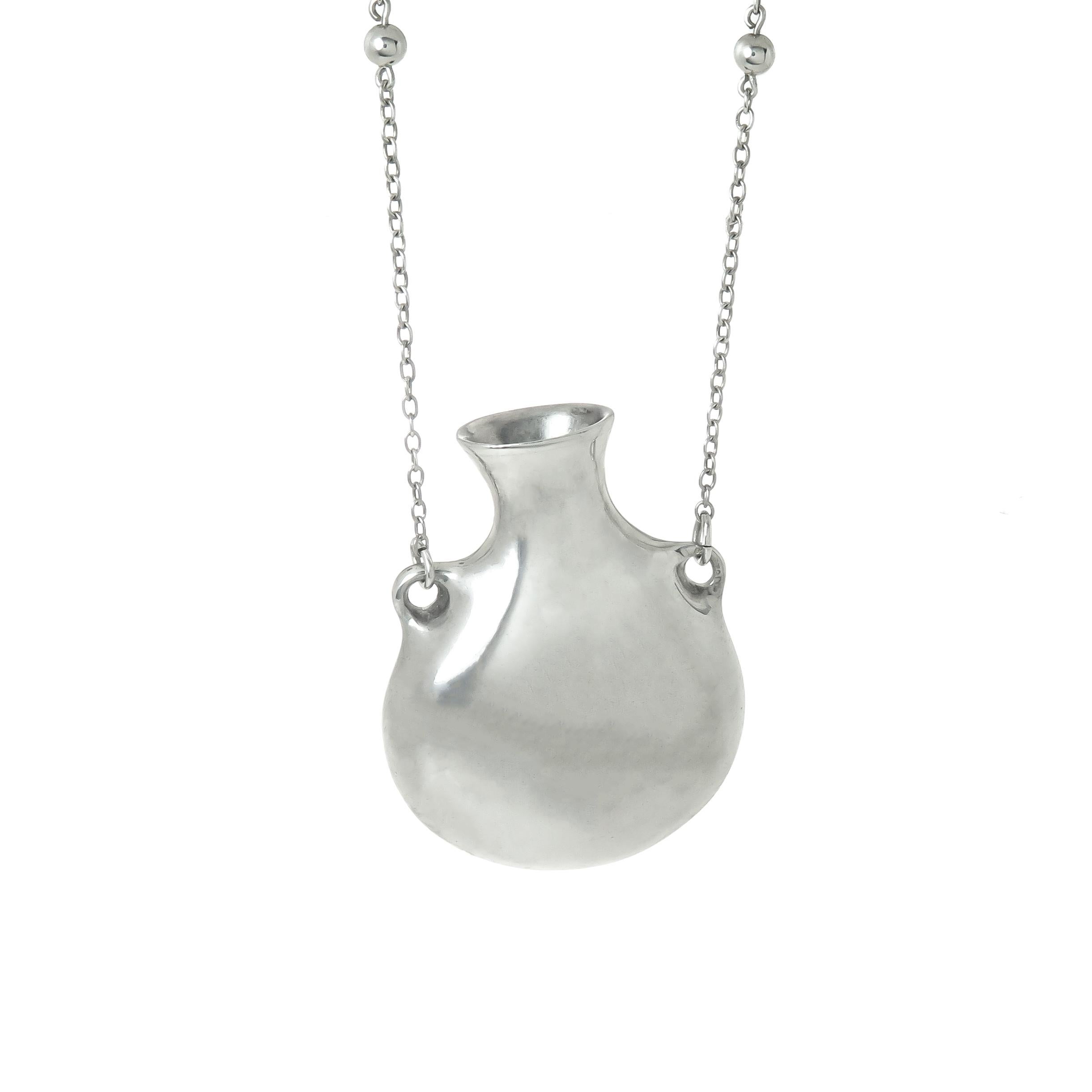 Circa 1990 Elsa Peretti for Tiffany & Company Sterling Silver Scent bottle Pendant Necklace. The bottle measures 1 3/4 X 1 1/4 inch and is suspended from a 30 inch chain.