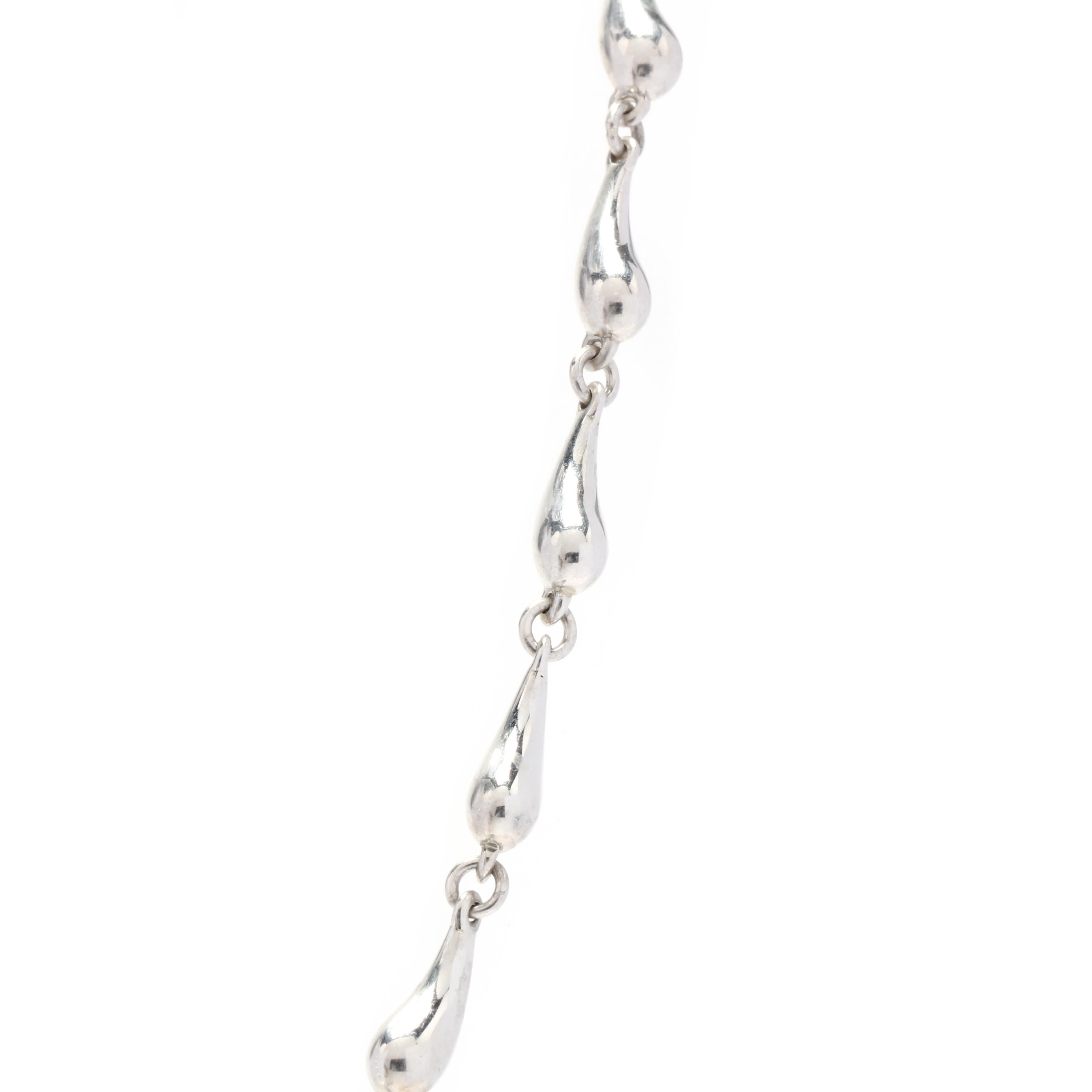 A sterling silver teardrop eternity chain design by Elsa Peretti for Tiffany & Company. This chain features teardrop motif links in an eternity design with a C clasp.

Length: 16 in.

Width: 3.6 mm

Weight: 16.5 grams