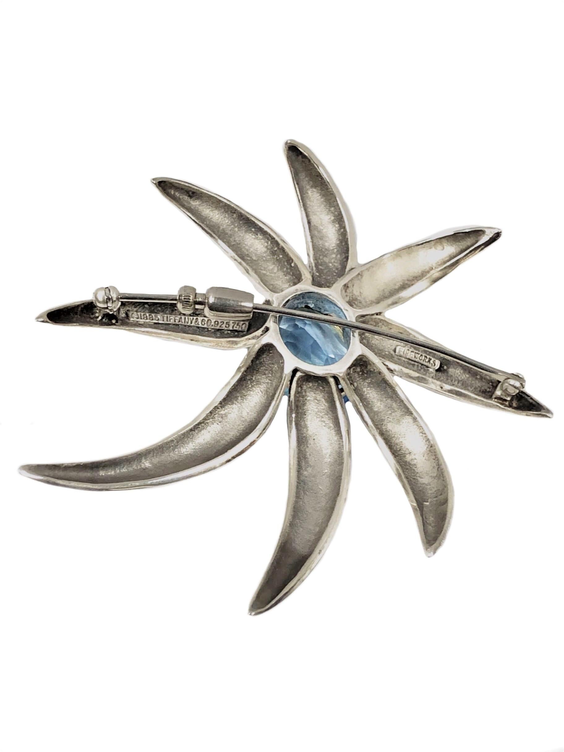 Circa 1990s Tiffany & Company Fireworks collection Brooch, Sterling Silver and 18K Yellow Gold and set with an Oval Royal Blue Topaz of approximately 6 Carats. The Brooch measures 2 3/4 X 2 1/2 inches. Comes in the original Tiffany & Company