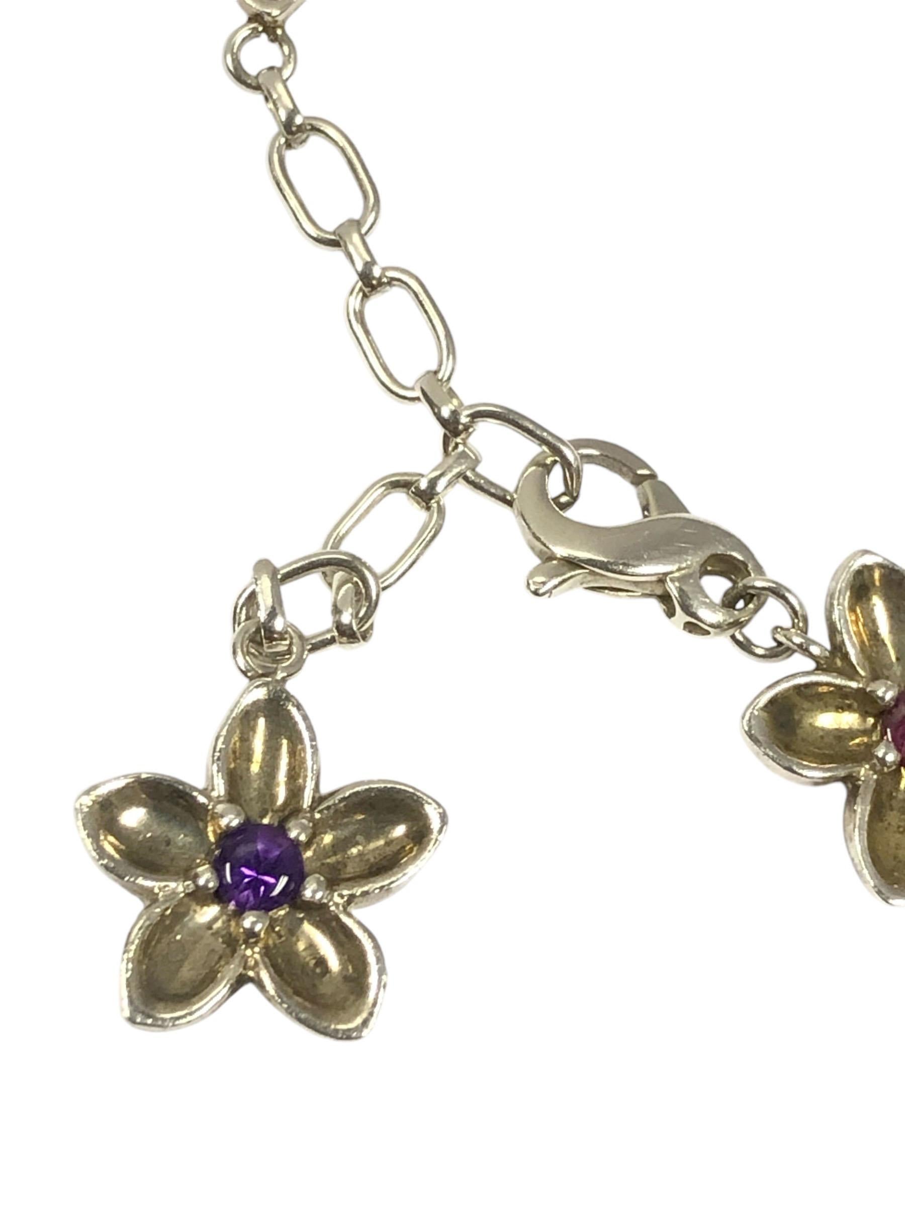 Circa 1990s Tiffany & Company Sterling Silver Flower Bracelet, this is from a short run limited collection, new and unworn in the original box, measuring 7 inches in length and is adjustable to be made larger, comprising of 10 linked flowers, each