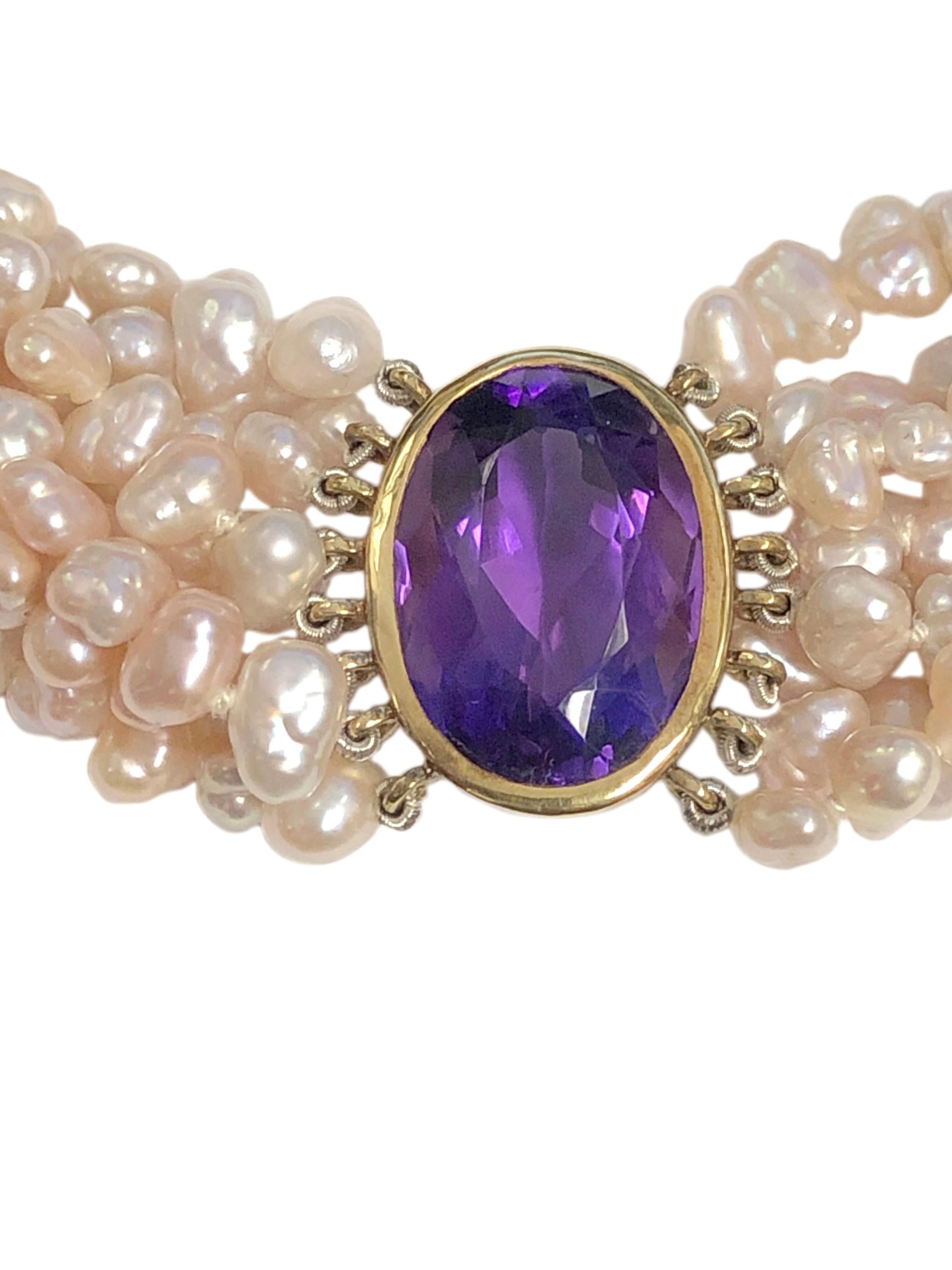 Circa 1990s Tiffany & Company Torsade Necklace, comprised of 8 strands of Natural fresh water pearls of various shapes measuring an average of 6 X 4 M.M. and having White Pink luster. Centrally set with an Oval Amethyst measuring 19 X 13 M.M. and